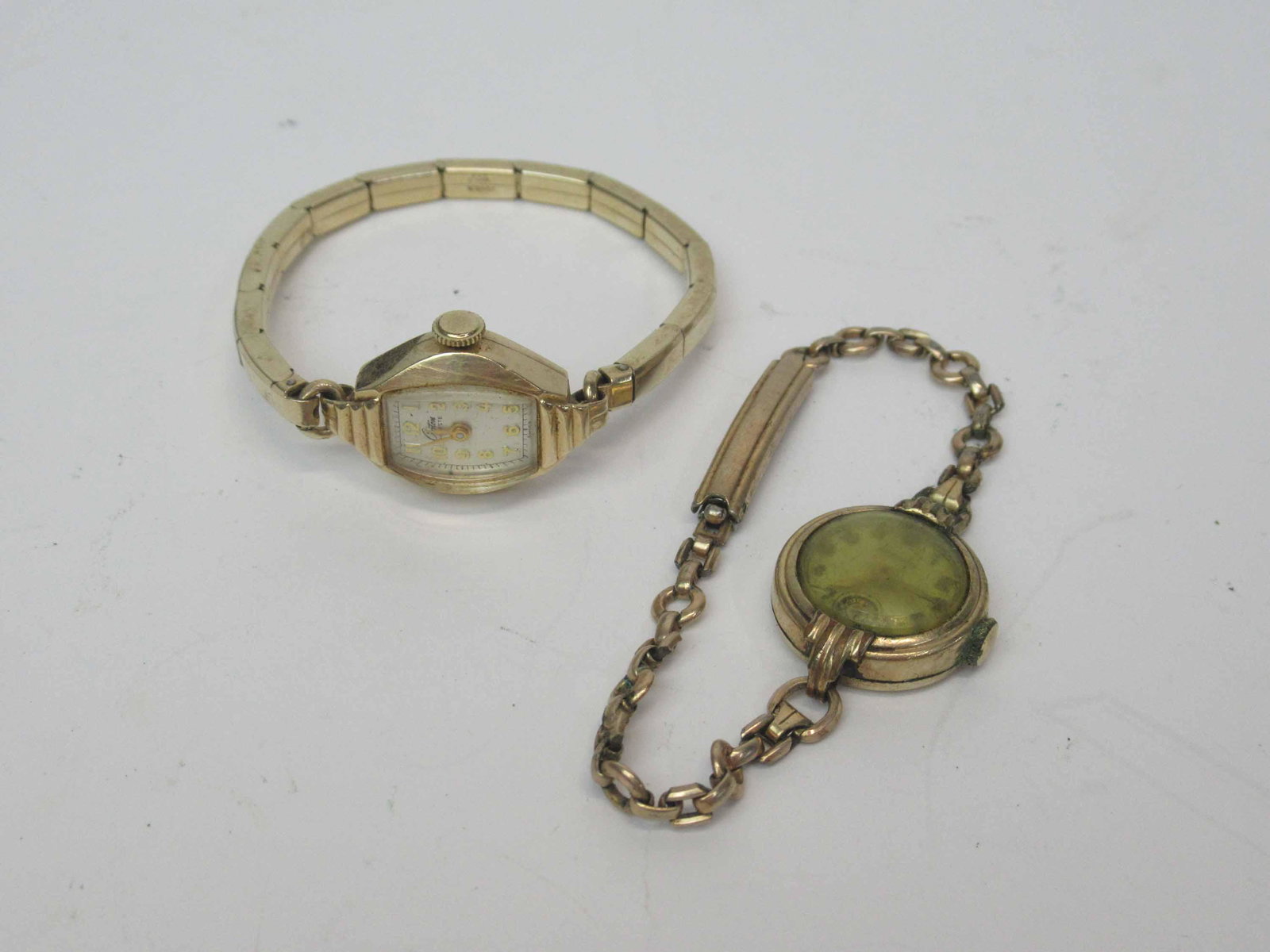 Two Croton Ladies Wrist Watch: One Croton Ladies 10K Gold Filled Wrist Watch, used unknown working condition, water damage. Gold toned in working condition.