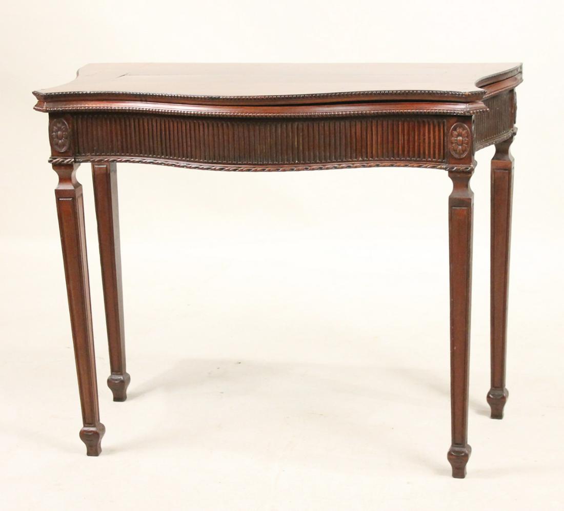 George III Mahogany Serpentine Front Game Table: English, c. 1775, with fluting, beading and rosettes, with secret drawer, manner of Thomas Chippendale Jr. 28-3/4"h x 25-1/2"w x 17-3/4"d Repairs to front left corner.