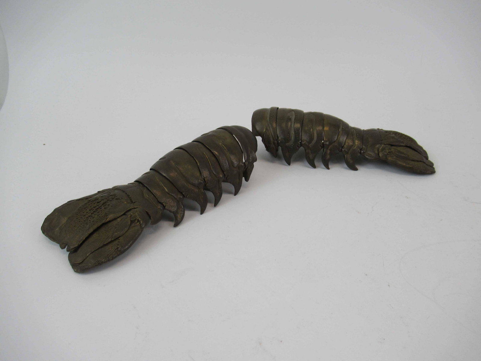 Pair of Brass Lobster Tails: Pair of Brass Lobster Tails. Articulated, possibly used as napkin holders. Used condition, 7"L