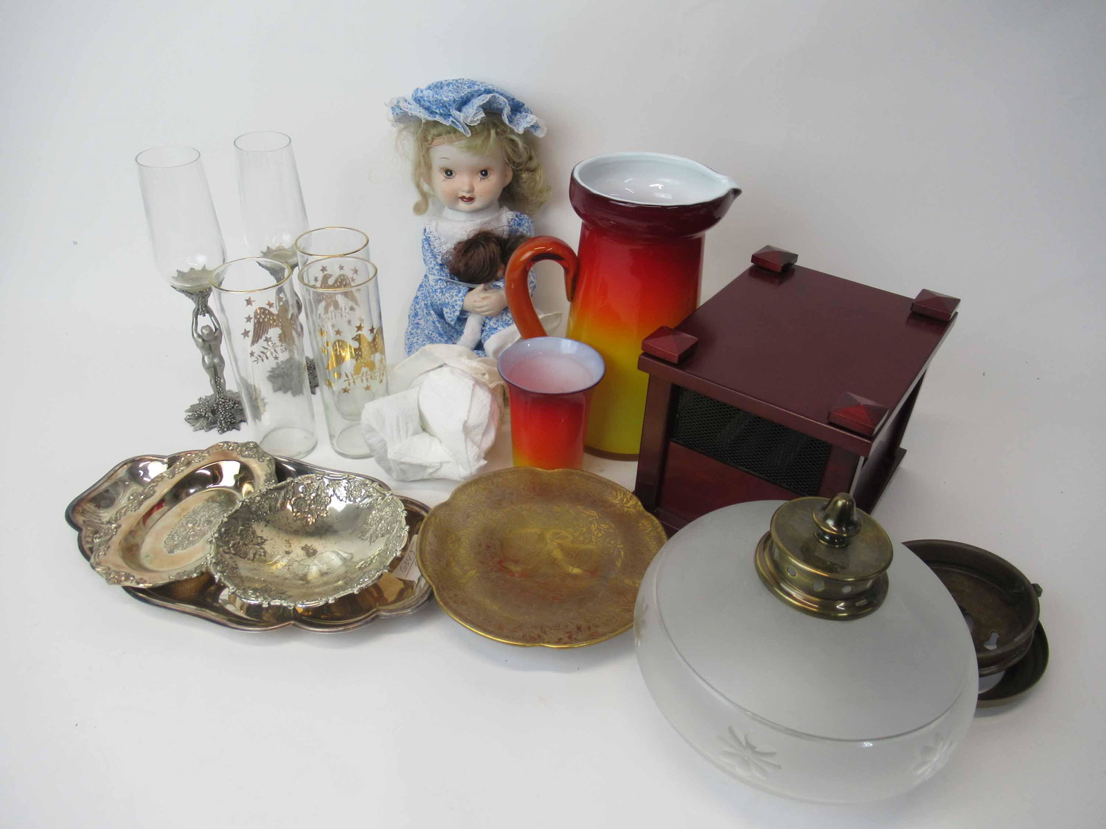 Group of Assorted Table Articles: Including, blown glass pitcher with cup, three american eagle glasses, two pewter wine glasses, a glass tray, doll, and silver plated trays.