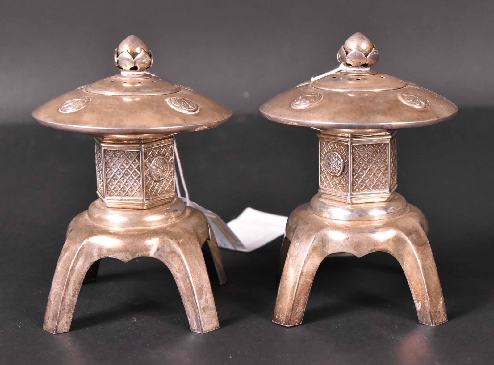 Pair of Chinese Export Silver Salt&Pepper Shakers: Stylized pagoda form, circular tops lotus rondels, each with removable pierced inserts, each 4-1/2"h, total weight approx. 12 T.O. Provenance: Property from the Collection of Myrna and Bernard Posner