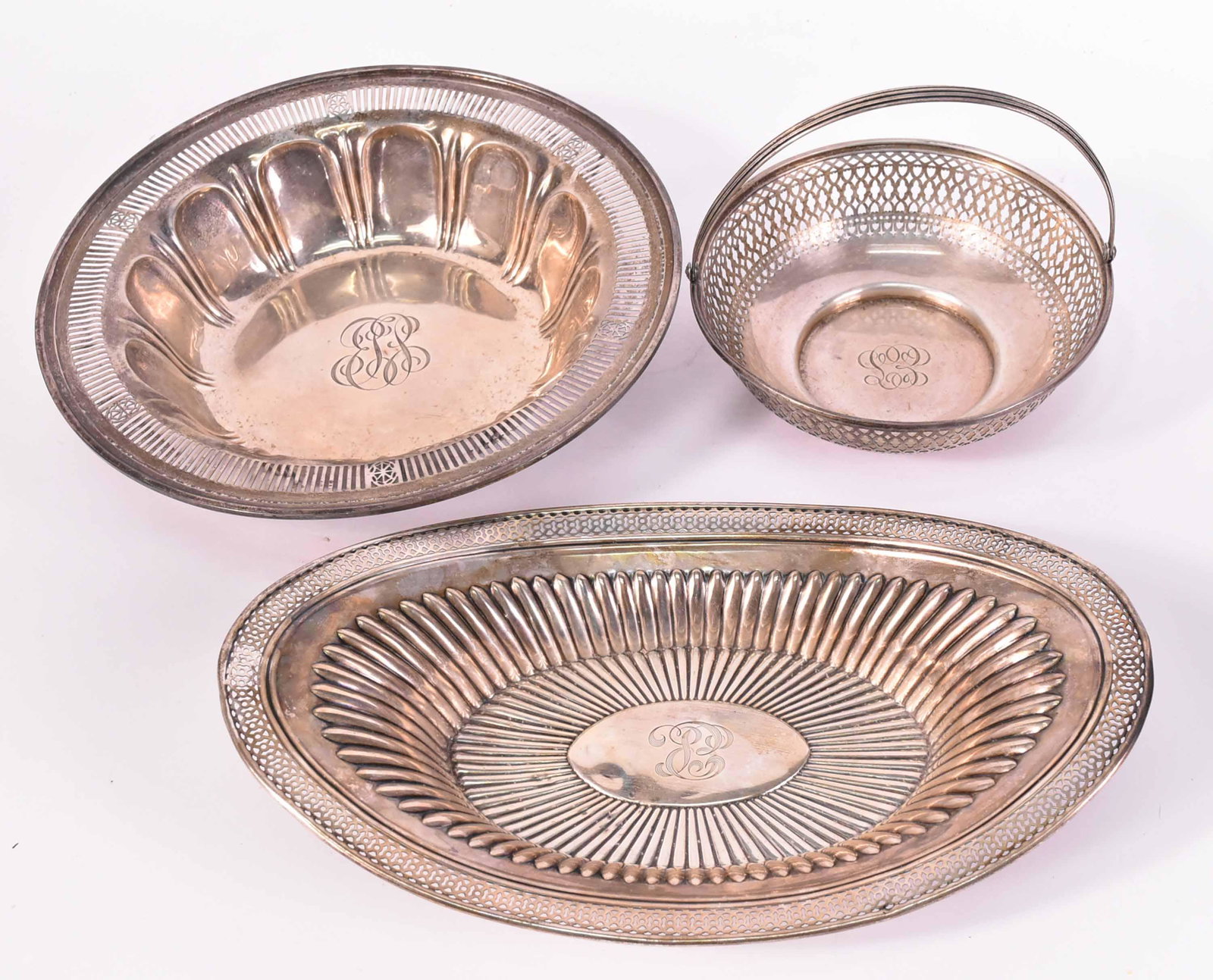 Three American Sterling Silver Table Items: Comprising an Alvin pierced handled circular basket, monogrammed, 6-1/2"d, a circular bowl with reticulated border, monogrammed, 10"d, and an oval bread tray with reticulated border and monogram, 12"l