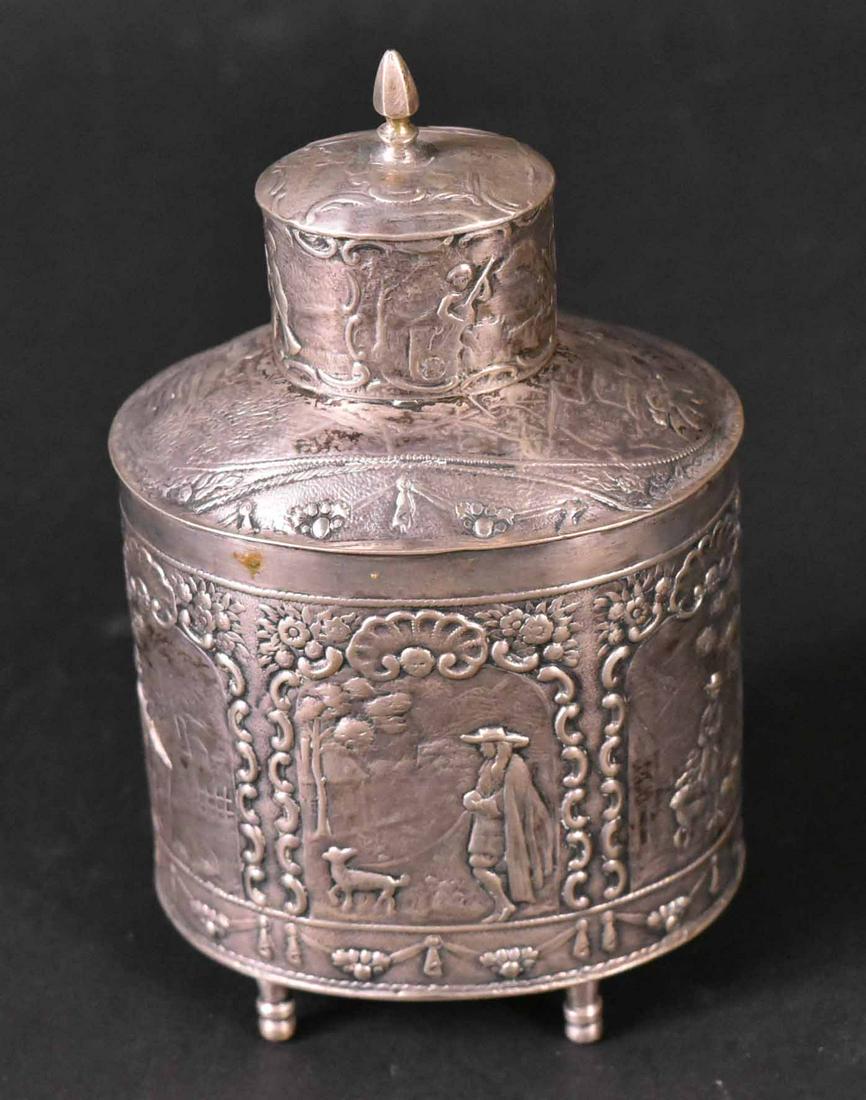 Dutch Silver Tea Caddy: All-over chased genre scenes, raised on four point feet, 4-3/4"h, weight approx. 4 T.O. Provenance: Property from the Collection of Myrna and Bernard Posner