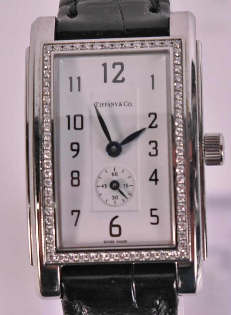 Tiffany & Co Stainless Steel & Diamond Wristwatch: Stamped on reserve Swiss Made Stainless Steel 070251137, rectangular white enamel face with black Arabic Numerals, and second hand, bezel set with small single cut diamonds, 25mm x 18mm, on black croc