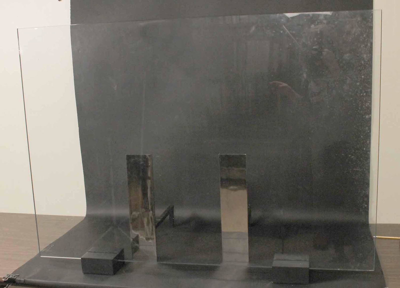 Custom Glass Firescreen & Pair of Modern Andirons: Chip to glass, andiron screws stripped, not fully attached to billet. Screen: 35-1/2"h x 49-1/2"w x 5"d, Andirons: 16-3/4"h x 4"w x 16-3/4"d