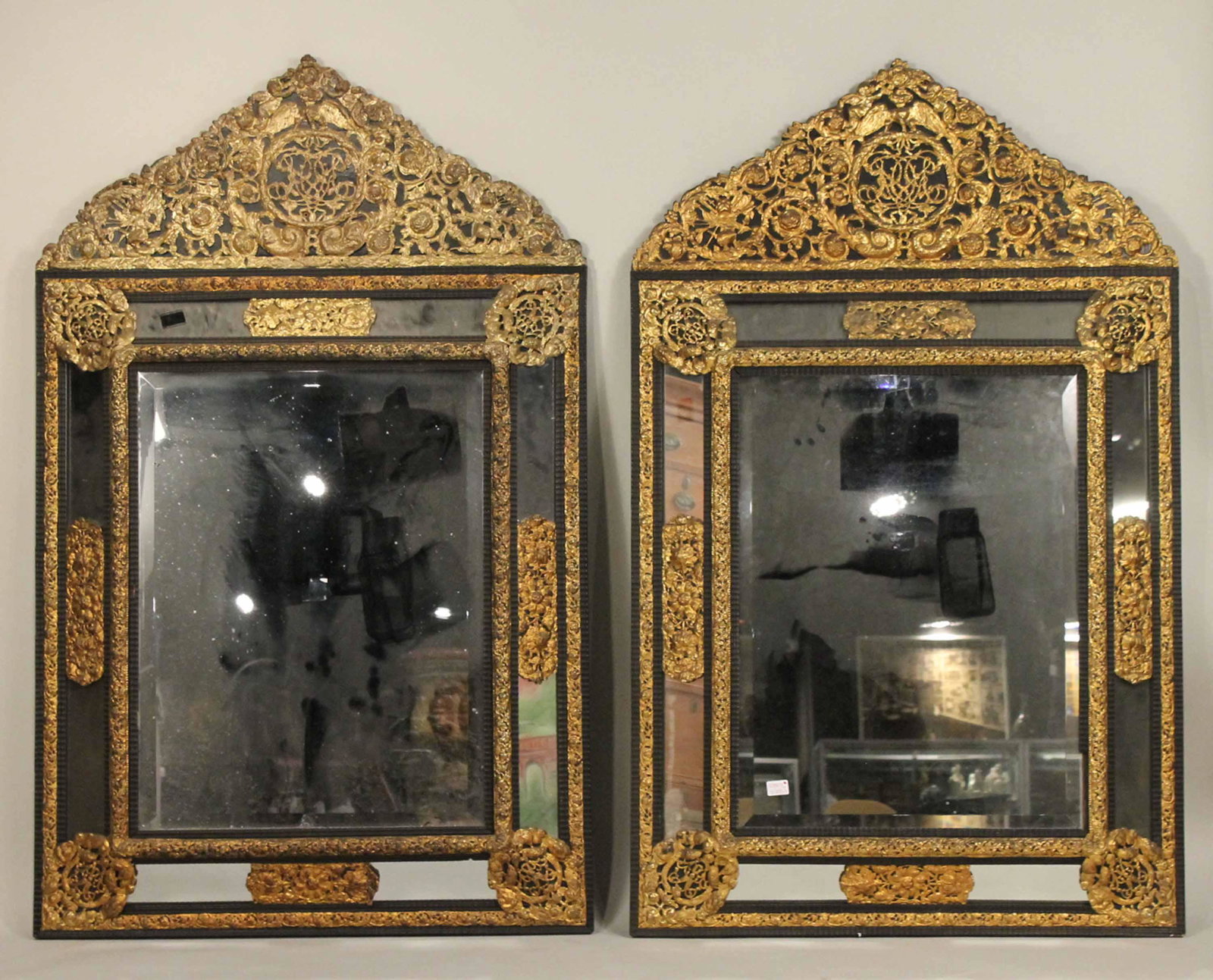 Pair of Large Baroque Style Cushion Mirrors: Baroque Taste, c. 1900, Dutch or Flemish, with ebonized wood and gilt-brass frames. One: 5'5"h x 41"w and 5'6"h x 40"w