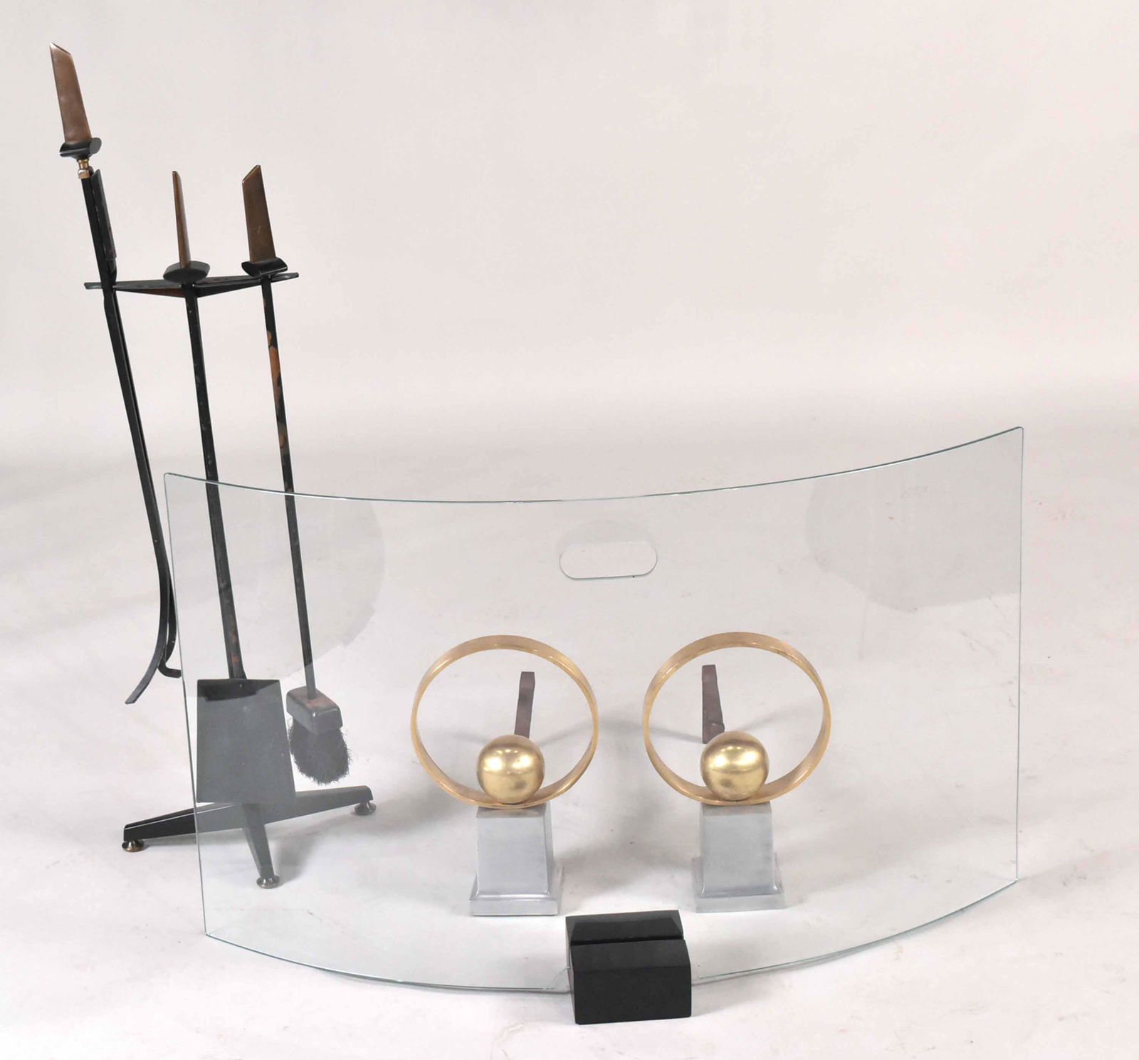 Group of Modern Fireplace Accessories: Comprising, a fireplace tool set, c. 1950s by Donald Deskey, pair of Art Deco andrions, c. 1940 by Jacques Adnet, and a crystal demi-lune fireplace screen. Black metal blocks do NOT belong with this f