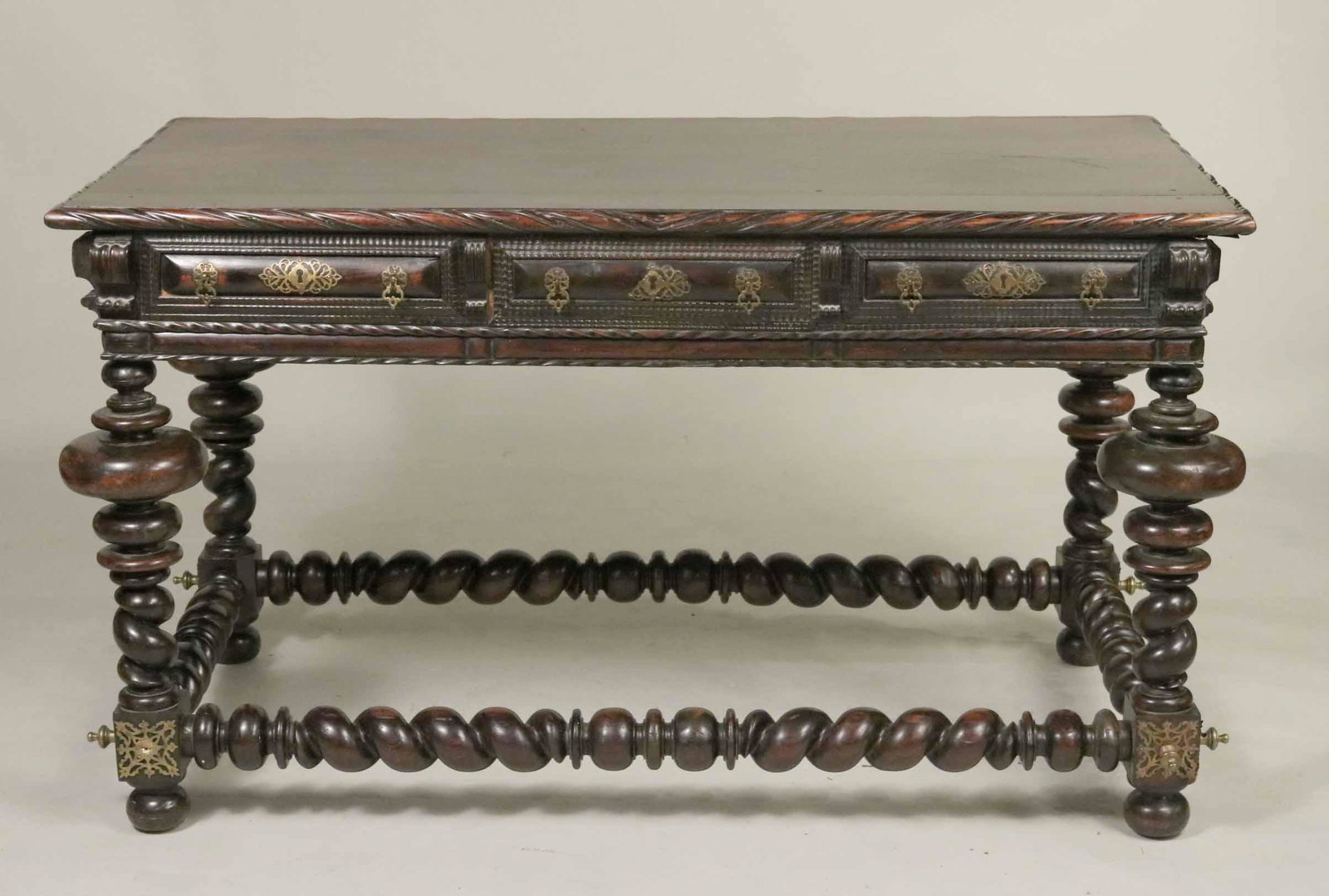 Spanish Baroque Metal-Mounted Oak Table: Continental, 18th C. with turned legs. Repairs to legs and stretcher. 33"h x 4'10"w x 30"d Provenance: Property from a Private Collection Illustrated in the New York Times' Real Estate Section, June 2