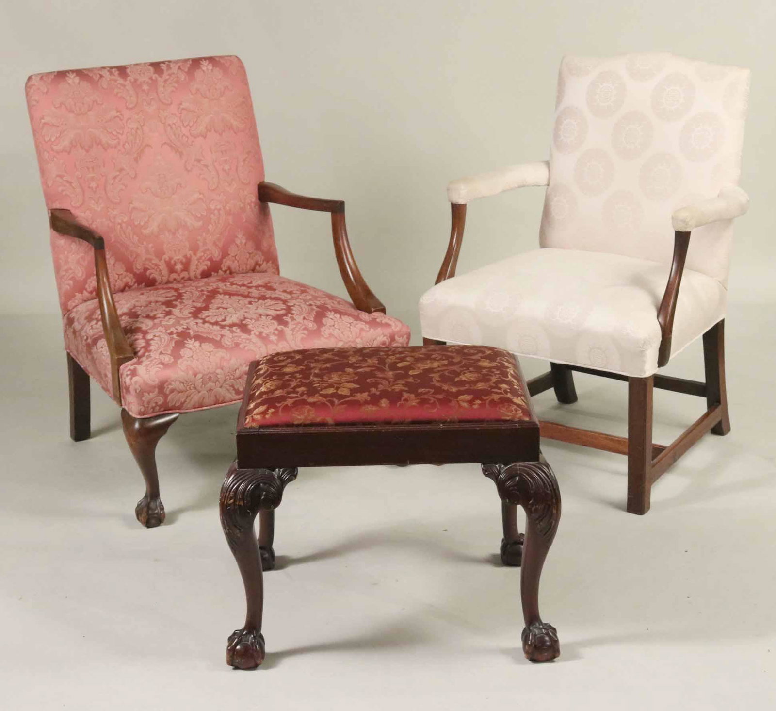 Two Mahogany Library Chairs and a Footstool: In the Federal and Chippendale styles, 20th C. 18-1/2"h x 18-1/2"w x 23-1/2"d, 36-14"h x 25-1/2"w and 35-1/2"h x 27-1/2"w