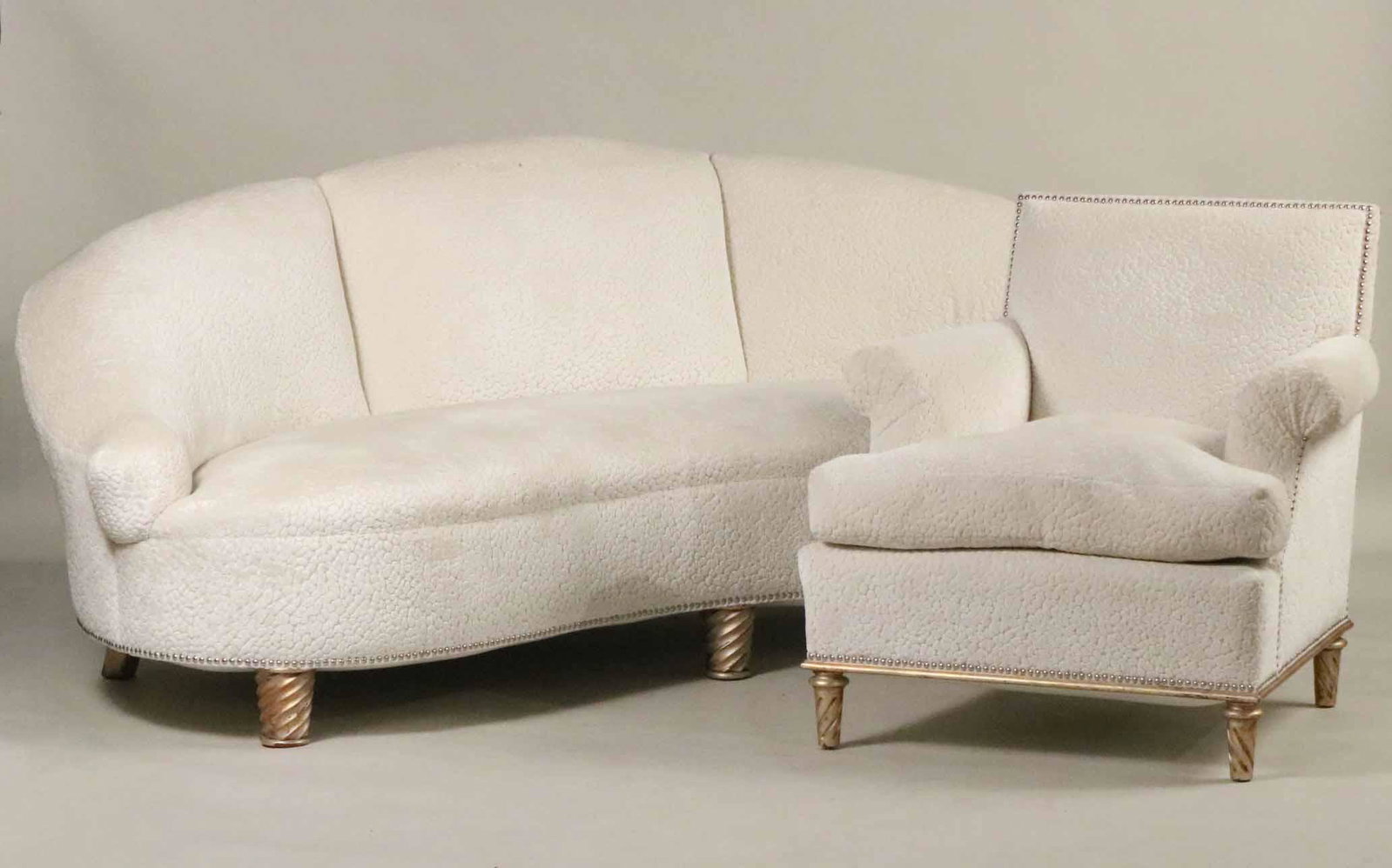 Contemporary White-Upholstered Chair and Sofa: Both upholstered in same fabric, but not matching. Repair to back center leg of couch. Couch: 33"h x 6'9"w. Chair: 21-1/2"h x 29"w Provenance: Property from a Private Collection Illustrated in the New