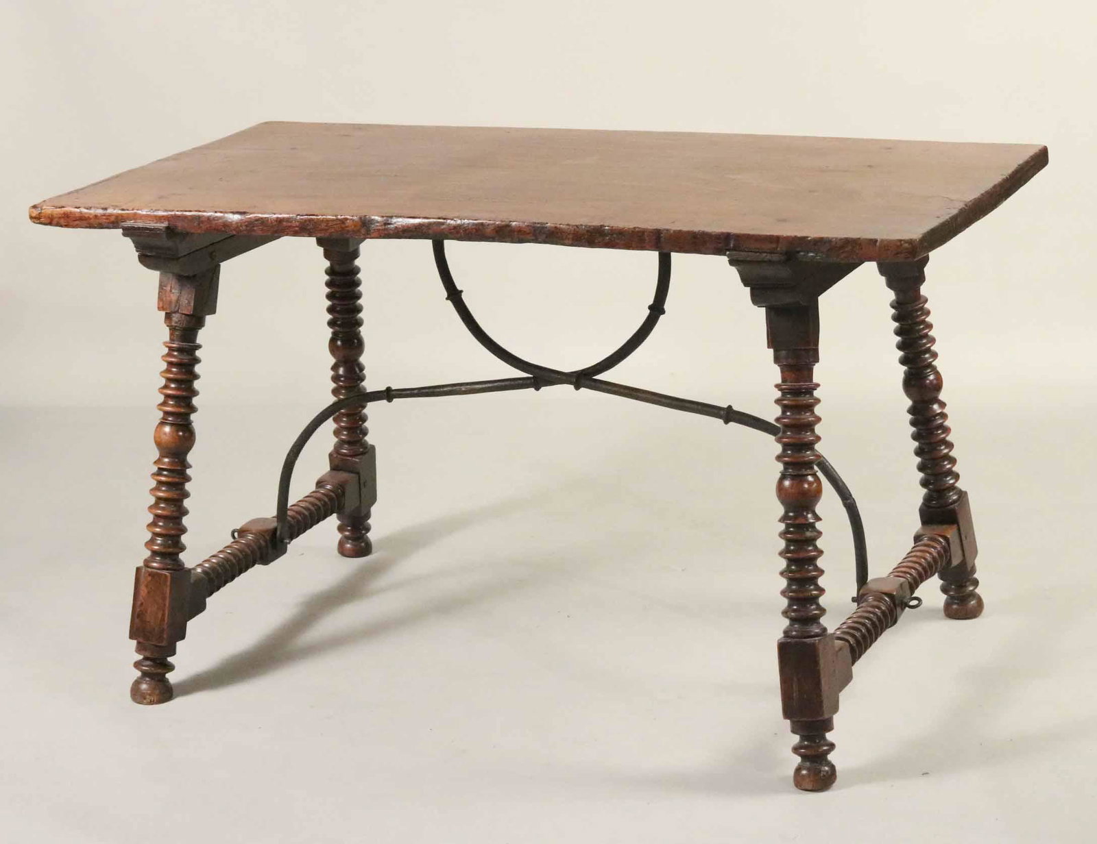 Spanish Baroque Walnut Trestle Base Table: Continental, 18th C., with metal supports. 39-1/4"h x 4-7-1/2"w x 29-3/4"d Provenance: Property from a Private Collection Illustrated in the New York Times' Real Estate Section, June 26, 2016, Park Av