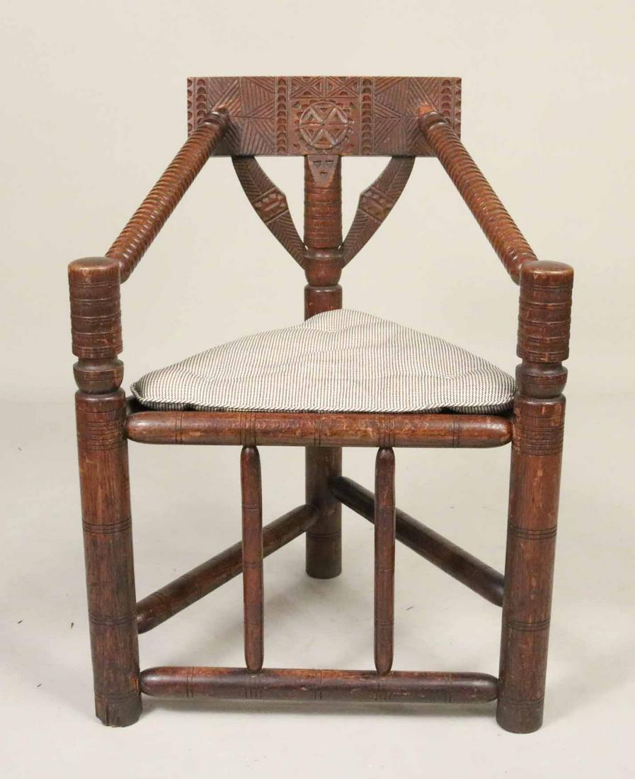 Arts and Crafts Carved Triangular Seat Armchair: Stamped CHS 1137 on inside of left leg. 33"h x 25-1/2"w x 21"d Provenance: Property from a Private Collection Illustrated in the New York Times' Real Estate Section, June 26, 2016, Park Avenue, NYC.