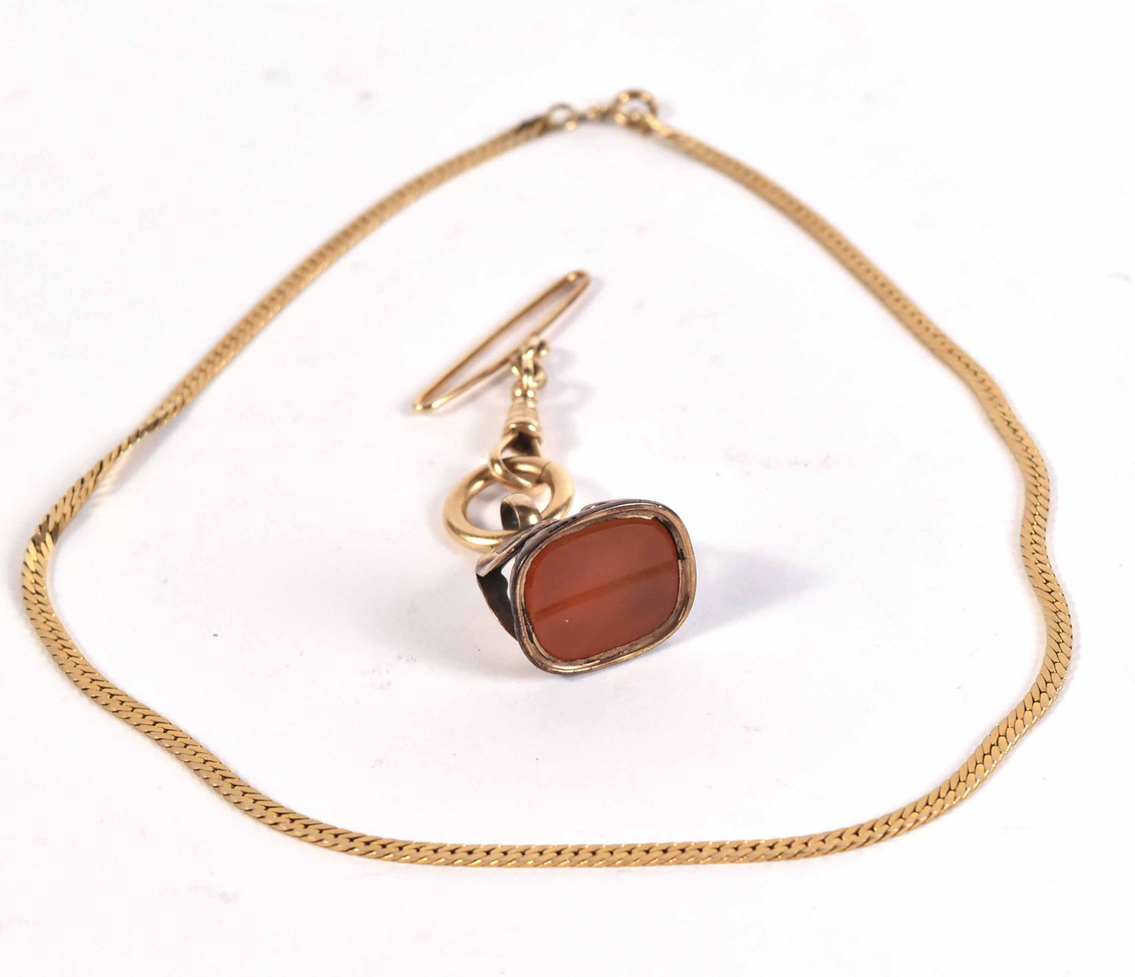 14K Yellow Gold & Gold Filled Victorian Watch Fob: Set with carnelian, 3/4"l x 1/2". Together with a stamped 14K yellow gold snake form chain necklace, 15"l, weight of only chain approx. 5.25dwts.