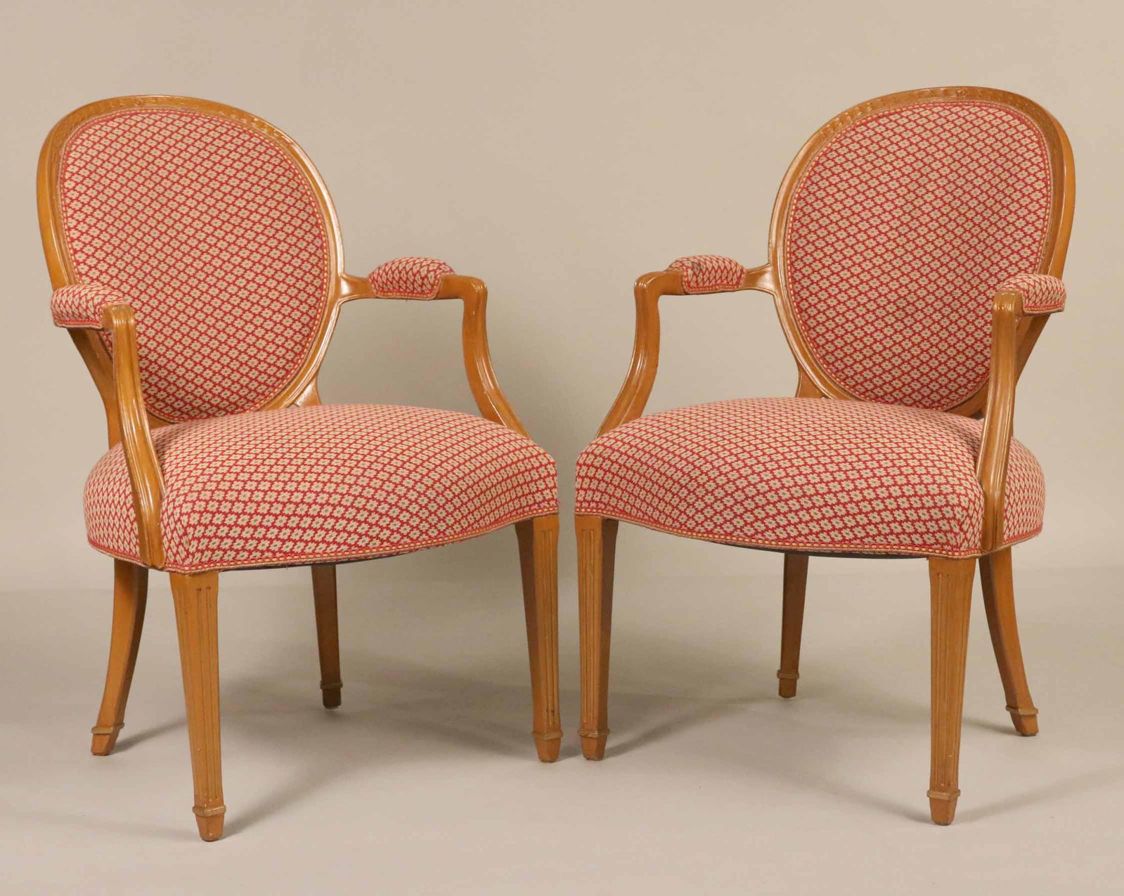 Pair of Louis XVI Style Yellow-Painted Fauteils: 20th C., with red, white, and green geometric fabric. 36"h x 24"w x 21"d