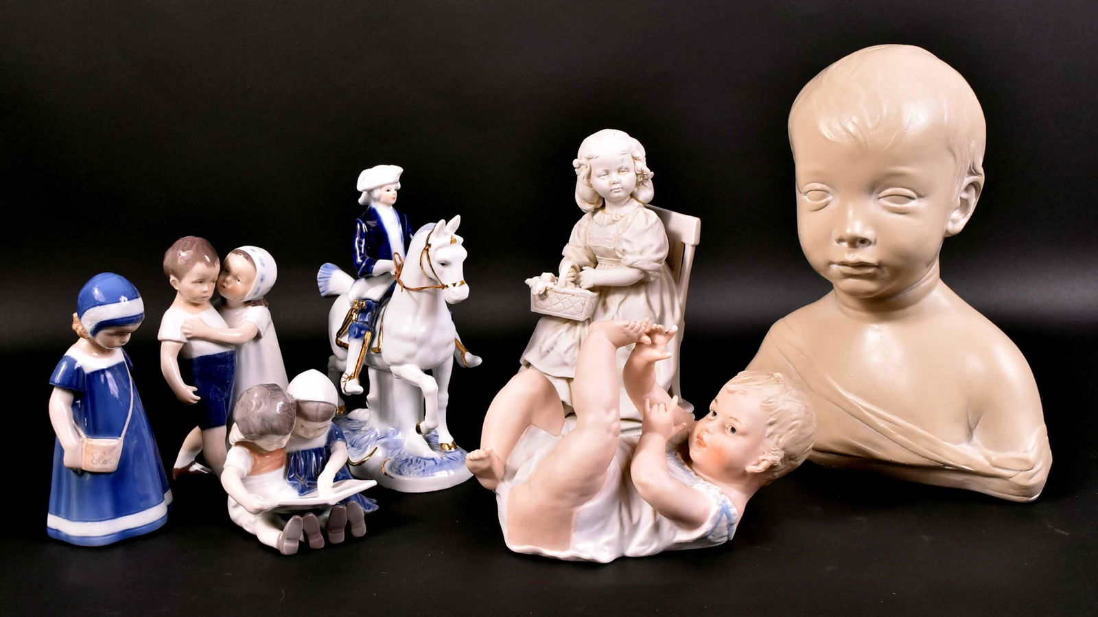 Three Royal Copenhagen Porcelain Figures: Together with a Capo-di-Monte porcelain figured of man on horse, a bisque figure of a baby, a German bisque figure of a seated girl, and an Austin Production bust of a young boy. 7 pieces