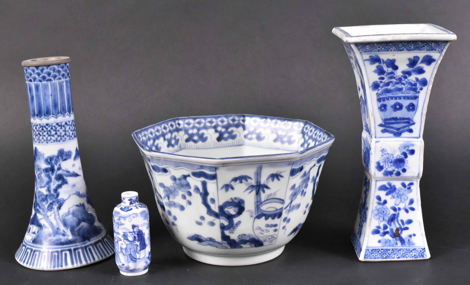 For Chinese Blue and White Porcelain Articles: 19th Century. Comprising an octagonal form bowl, two tall vases, one with metal mounted rim and a miniature vase. Size: Tallest 8 1/2"h Condition: chips and wear. Property from the Estate of Ralph & R