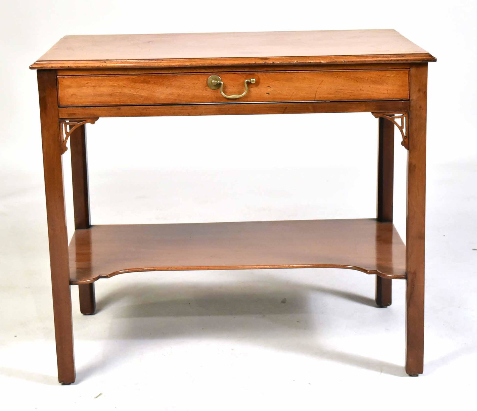 George III Mahogany Dressing Table: English, late 18th C. the rectangular top with molded edge above a single drawer, on square legs with pierced knee brackets and joined by a shaped stretcher. 28"h x 32-1/2"w x 18-1/2"d Property from t