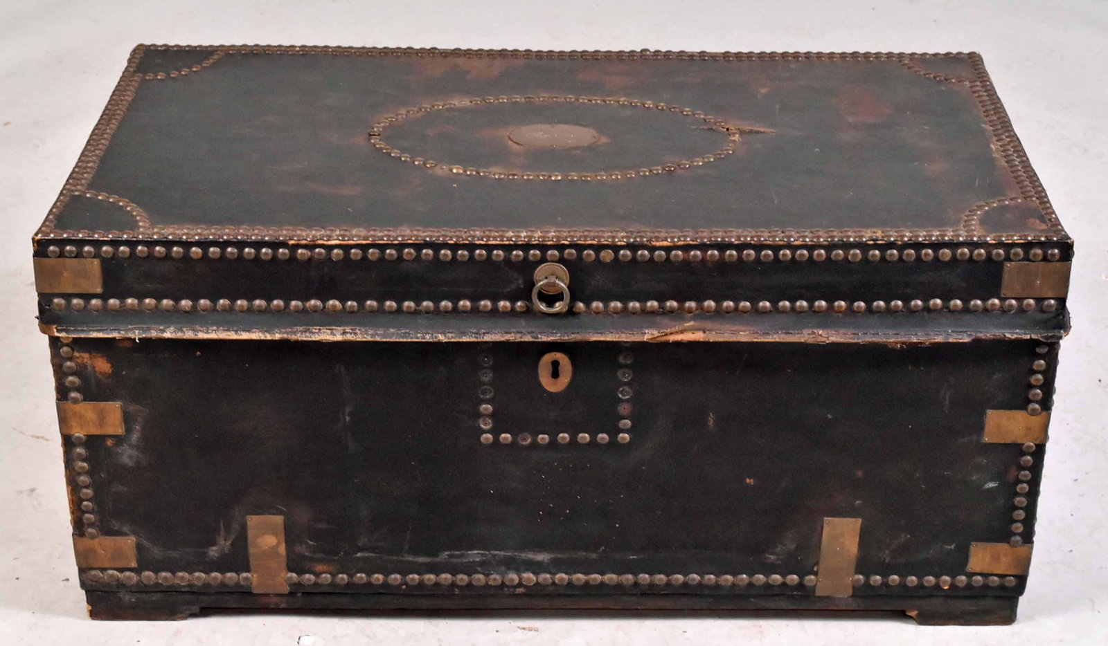 Brass-Tack and Black-Leather Footlocker: 19th C., with brass plaque-inscribed "Sam Brown." Losses to leather. 16"h x 36-1/2"w x 19"d Property from the Estate of Ralph & Roberta Carpenter.