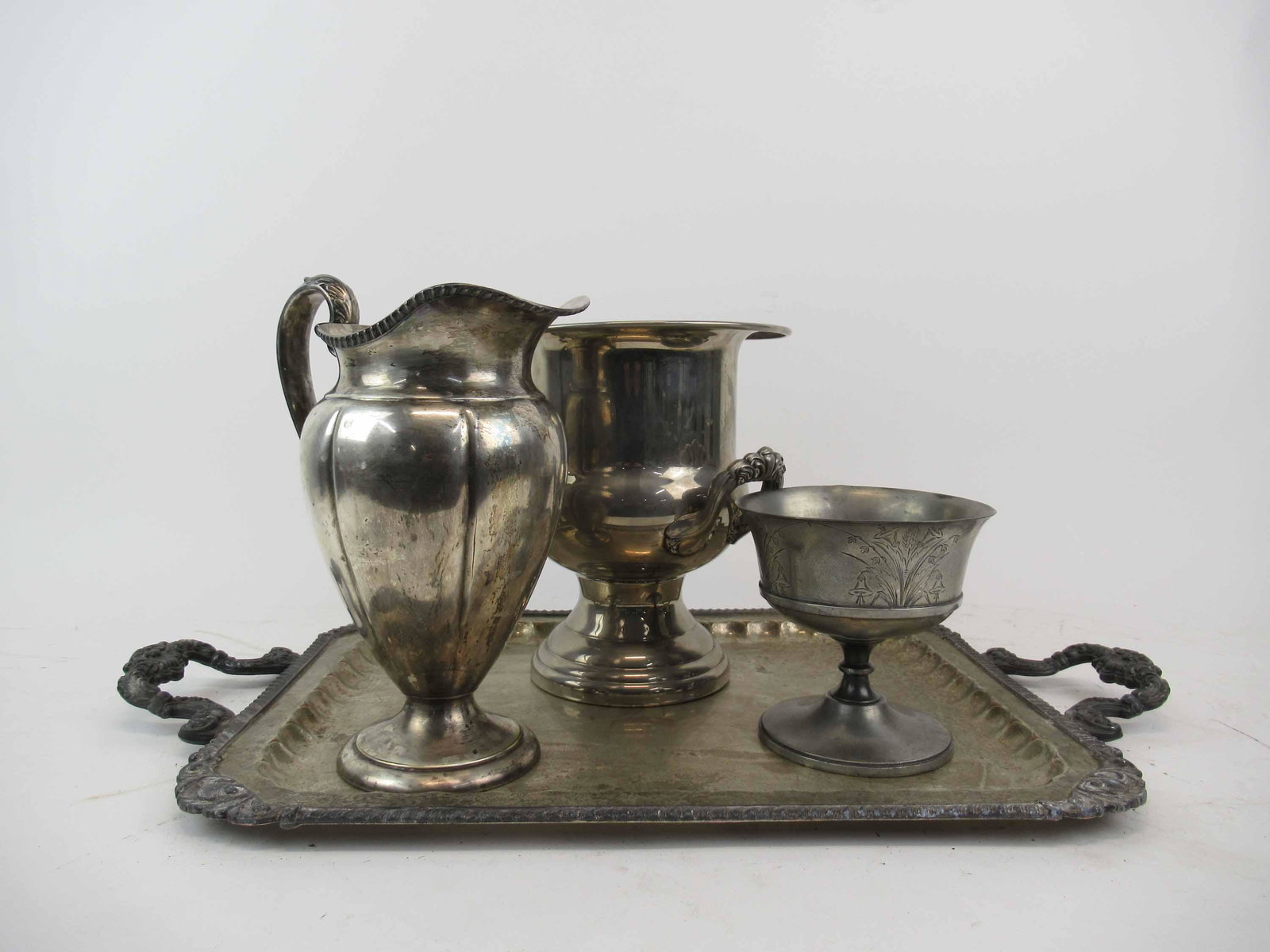 Silver Plated Double Handled Serving Tray: Silver Plated Double Handled Serving Tray together with a water pitcher, a wine cooler, and pewter footed compote. Used condition, wear, worn, scratches. Serving Tray 27" handle to handle