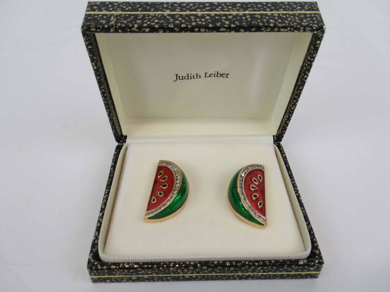 Pair of Judith Leiber Watermelon Enamel Ear Clip: Red & green enamel with crystal on gold tone metal, stamped Judith Leiber in original box, each 1-1/4"l.