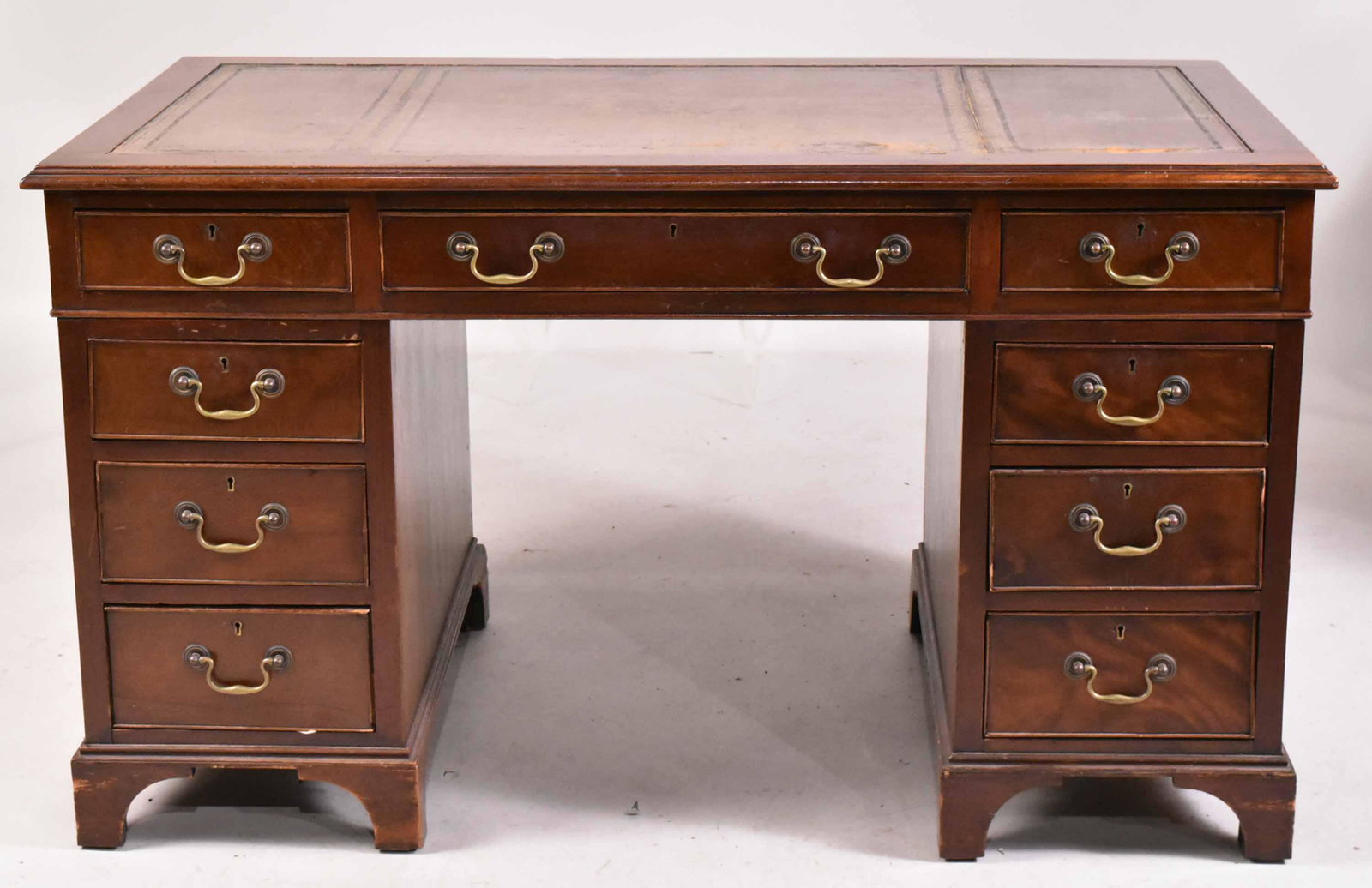 George III Style Mahogany Double Pedestal Desk: English, late 19th C., the rectangular top with gilt-tooled green leather writing surface above three frieze drawers over two pedestals, each having three short drawers and bracket feet. 30"h x 4'5-1/