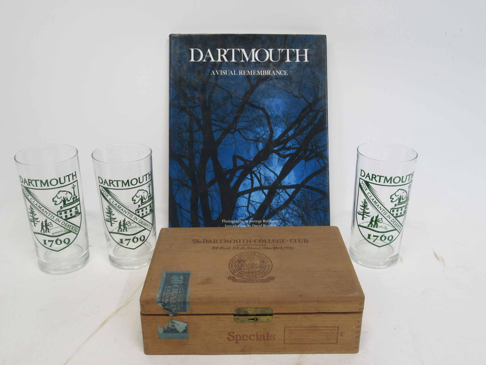Three Dartmouth College Commemorative Glasses: Three Dartmouth College Commemorative Glasses, the collegiate Collection from Coca Cola Company. Together with a Dartmouth book and cigar box. Used condition, glass size 6" tall x 3" diameter.