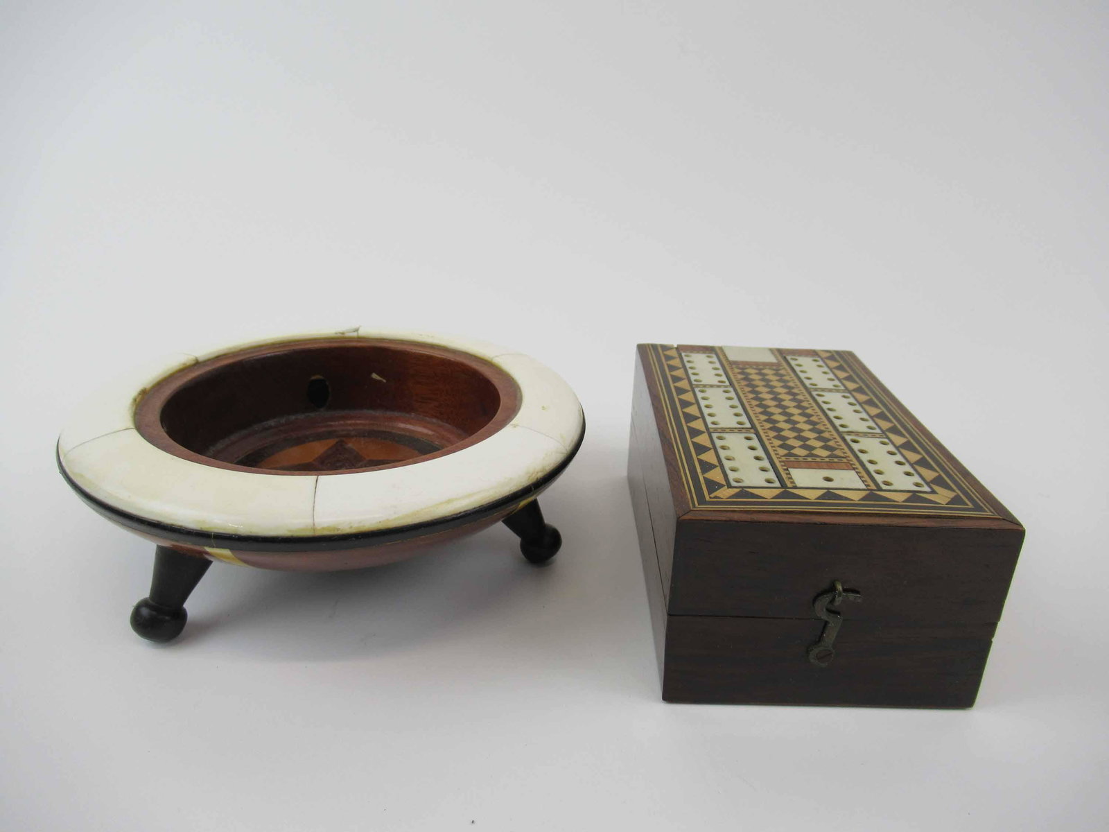 Marquetry Inlaid Wooden Caddy: Marquetry Inlaid Wooden Caddy with bone border resting on three legs. Together with a Marquetry and bone inlaid cribbage box. Used condition, wear, worn, cracks, split. Maybe missing pieces. Bowl meas