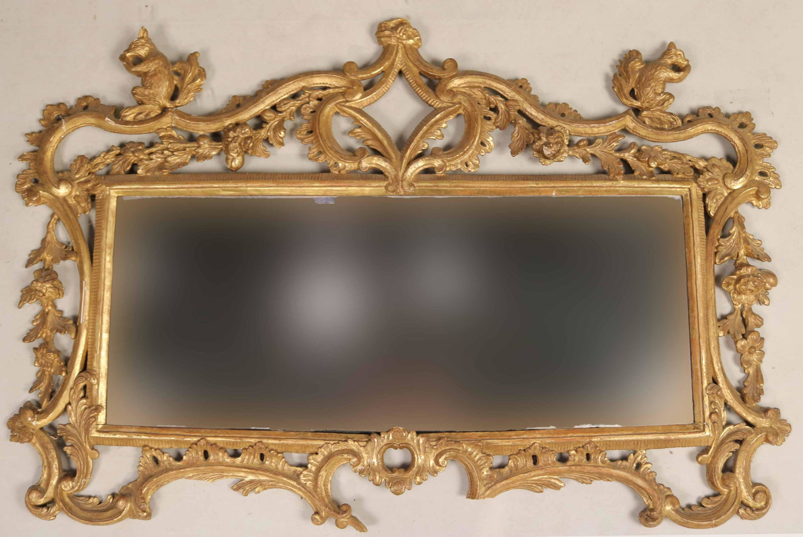 Rococo Giltwood Wall Mirror: English, 18th C., with squirrel decoration Losses and breaks. 30"h x 45"w Provenance: Property from the Estate of Judith Applegate, Princeton, NJ.