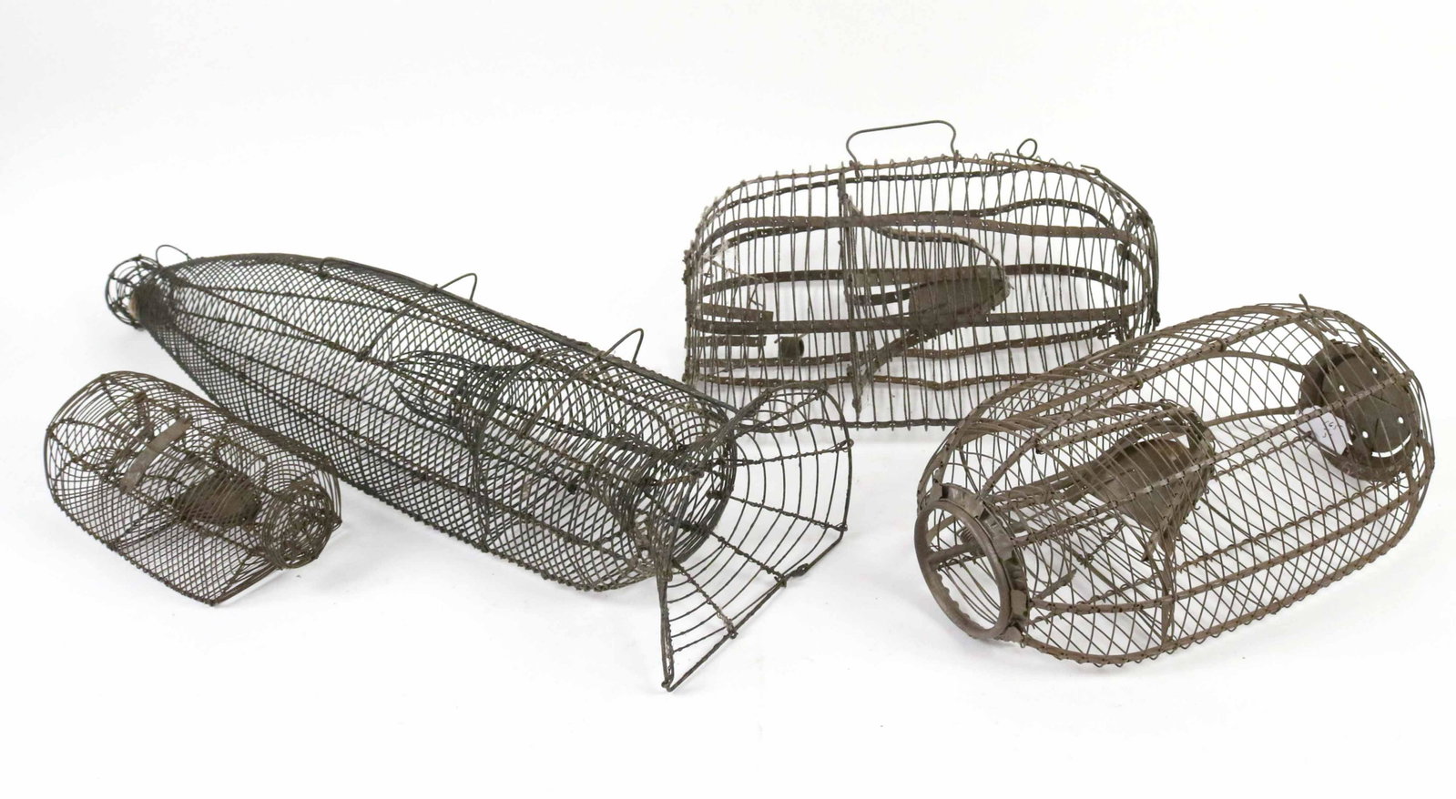 Four Wire Animal Traps: Including a mouse trap, minnow trap and a two rat traps. Size: 26 1/2"l Provenance: Property from the Estate of Judith Applegate, Princeton, NJ.