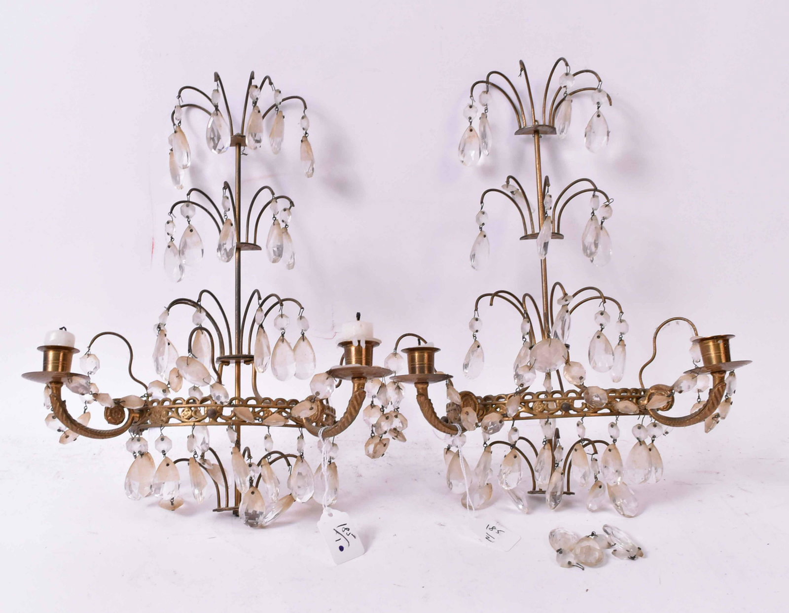 Pair Gilt Metal Two Arm Wall Sconces: With three tiers of crystal prisms. Size: 17"h Provenance: Property from the Estate of Judith Applegate, Princeton, NJ.