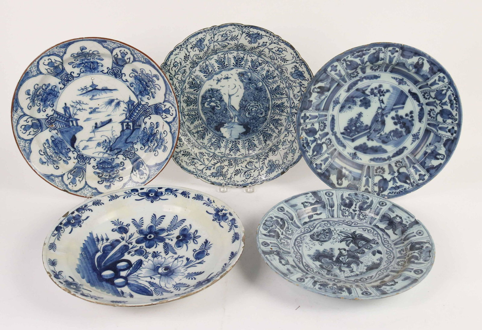 Five Blue and White Tin Glazed Earthenware Plates: Dutch, 17th/18th Century. Comprising a Delft charger with a Rockwork motif, a Delft charger with a Chinoiserie motif, two Delft "Wan-Li" chargers and a Delft Chinoiserie charger, De Biji Factory. Size
