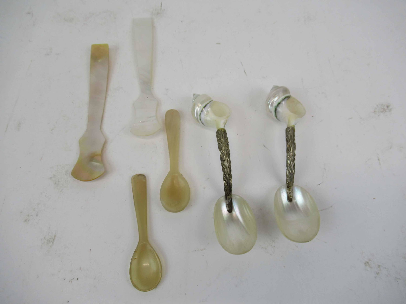 Pair of Mother of Pearl Seashell Caviar Spoons: Pair of Mother of Pearl Seashell Handled Caviar Spoons. Together with assorted caviar spoons. Used condition, wear, worn. Mother of Pearl measures 4 3/4" long