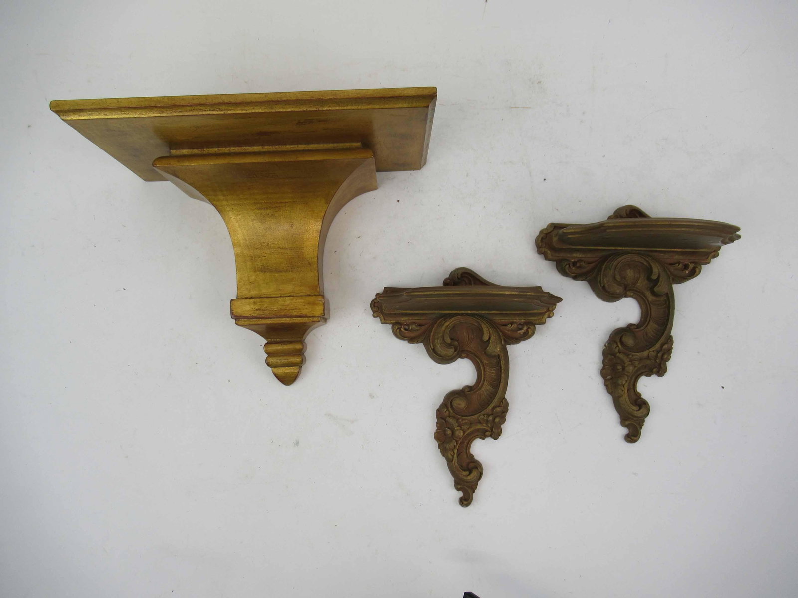 Pair of Syracuse Giltwood Wall Brackets: Pair of Syracuse Giltwood Wall Brackets. Together with a giltwood wall bracket. Used condition, chips. Largest bracket 8 1/2" tall x 11" wide x 6" deep