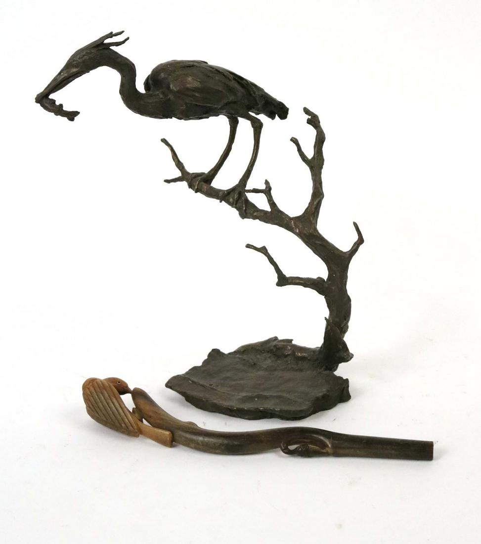 Bronze Sculpture Heron on Branch Mark Hopkins: (American, 20/21st century) Signed and numbered on base Mark Hopkins, 87/2500 and dated 1989. Together with a carved bone sculpture bird on a stick. Size: 11"h