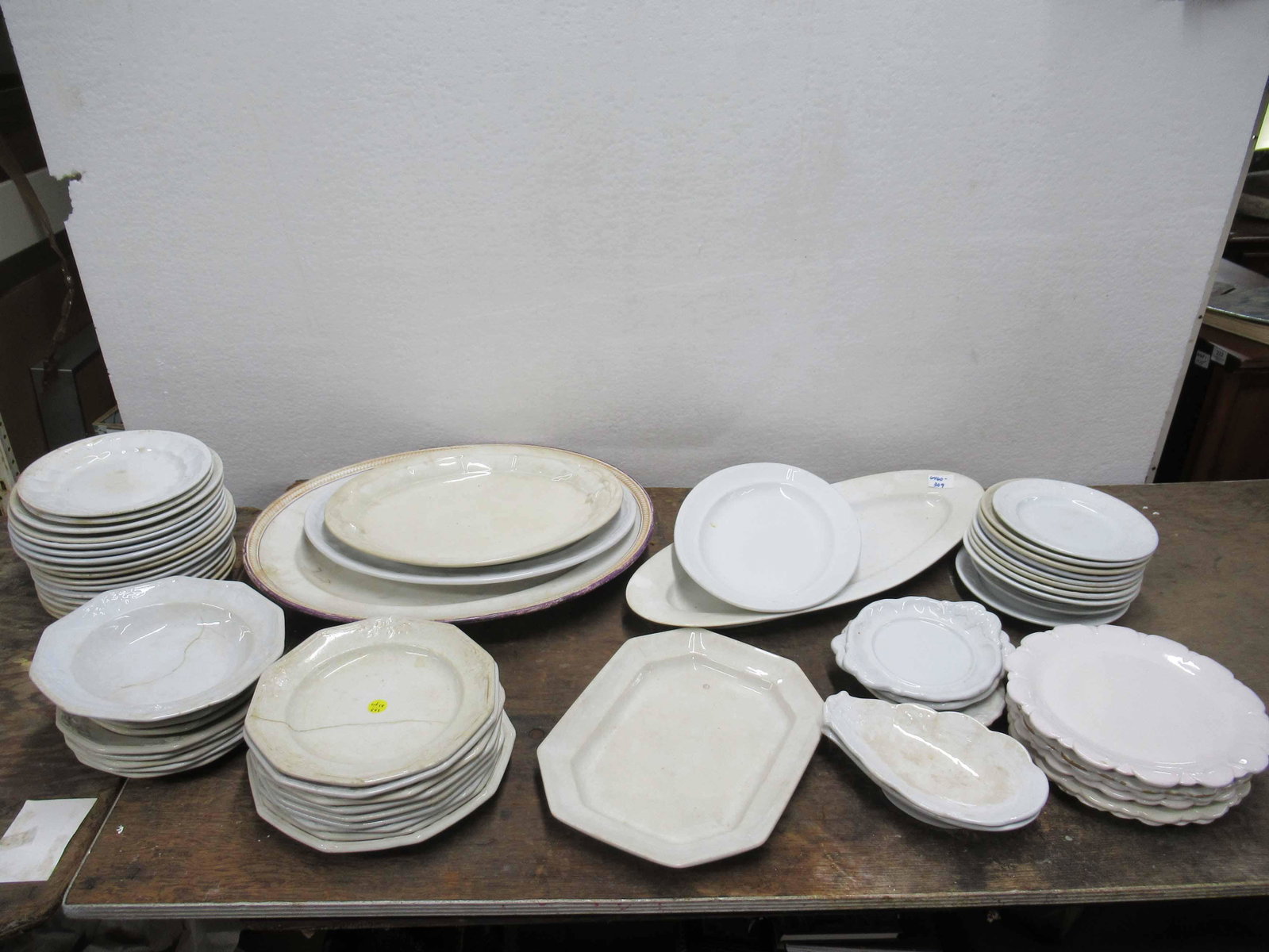 A Group of Assorted Ironstone Dishes and Platters: A Group of Assorted Ironstone Dishes and Platters. Includes assorted sizes and shapes. Used condition, wear, worn, chips, cracks, stains.