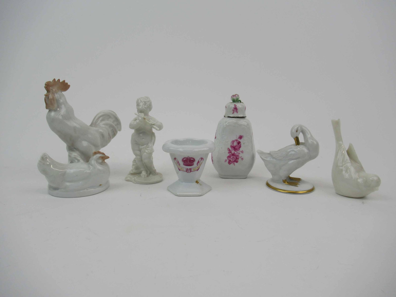 Rosenthal Porcelain Rooster and Nesting Hen: Rosenthal Porcelain Rooster and Nesting Hen 5"h. Together with a Lenox song bird, a goose, a musician, and a Hotel Scribe footed vessel, and a covered bottle. Used condition, wear, worn. Losses.