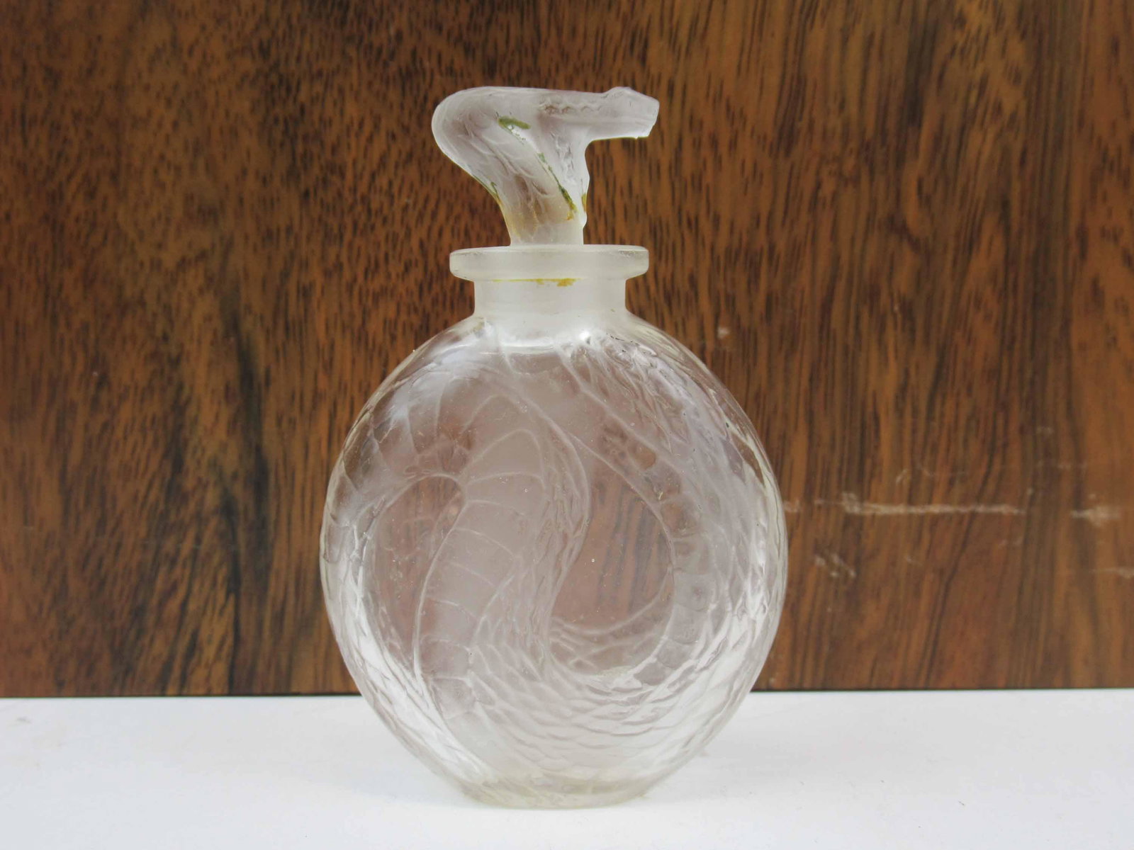 Lalique France Serpent Frosted Perfume: Lalique France Serpent Frosted Perfume with clear and frosted glass, used condition, some flea bites.3 1/4" tall x 2 1/4" wide. Together with three assorted perfumes.