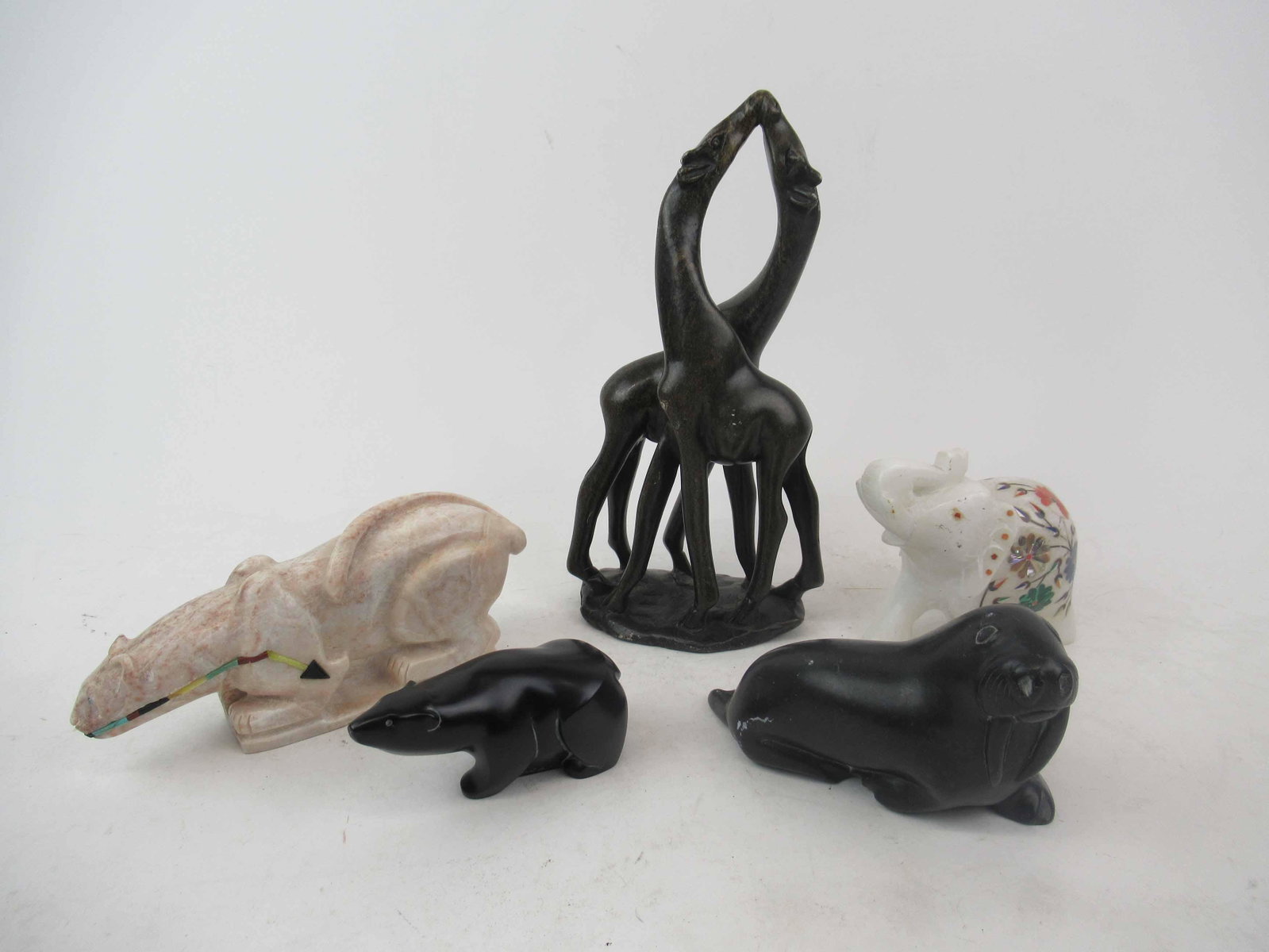 Group of Assorted Stone Animal Figurines: Group of Assorted Stone Animal Figurines including Inuit Walrus, Panther, Elephant, Giraffe & composition Polar Bear. Used condition, wear,worn, surface distress, chips. Giraffe size 10 1/2" Tall x 5 