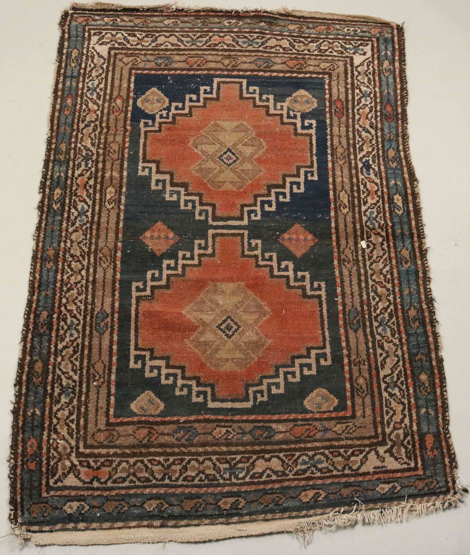Caucasian Rug: Early 20th C., worked in tones of red, ochre, and brown. 4'6"l x 38"w Provenance: Property from the Estate of Judith Applegate, Princeton, NJ.