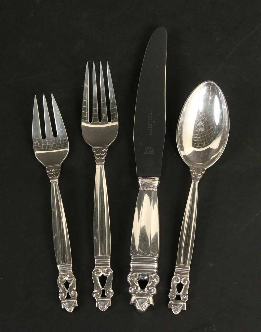 Georg Jensen Acorn Sterling Silver Flatware: Acorn pattern, comprising 6 dinner knives with stainless steel blades, each 9"l, 6 dinner forks, each 7-1/2"l, 6 place spoons, 6 salad/dessert forks, weight without knives approx. 30 T.0, and 1 hollow