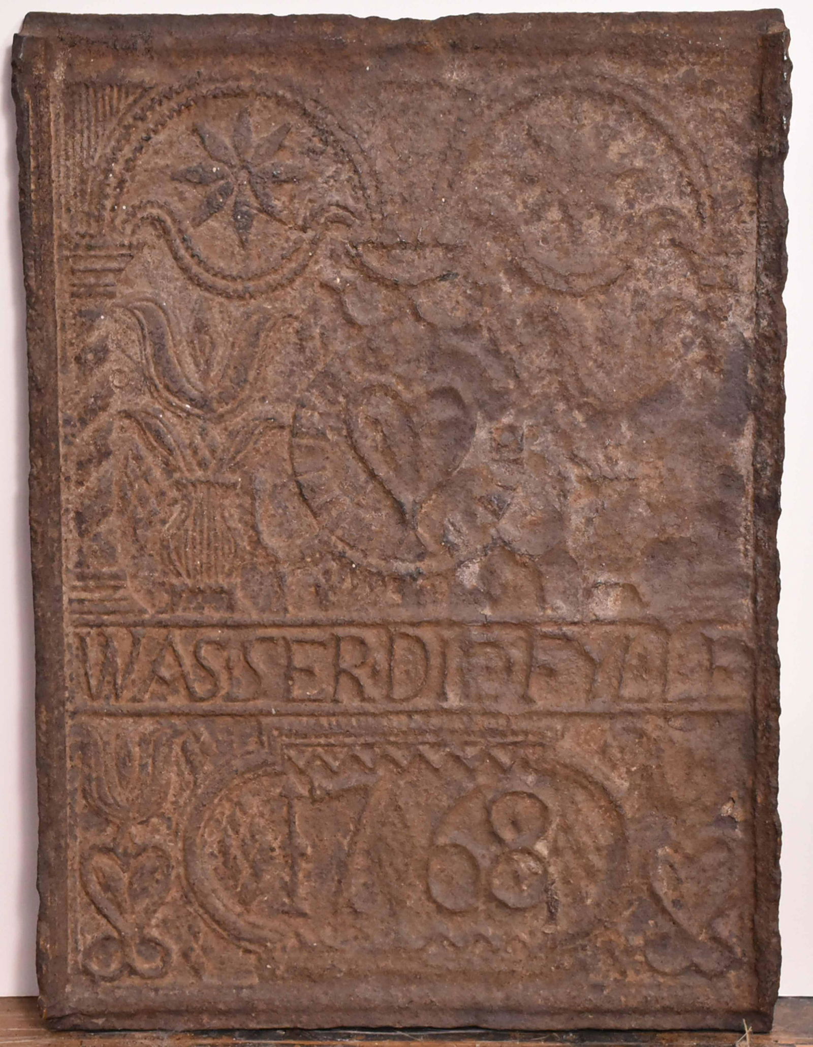 Cast-Iron Stoveplate, God's Shield: Pennsylvania, dated 1768, inscribed "Wasser Die FYL. LE," decorated with flowers and hearts. 21-1/4"h x 18"w Provenance: Property from the Collection of Eric Martin Wunsch, New York City
