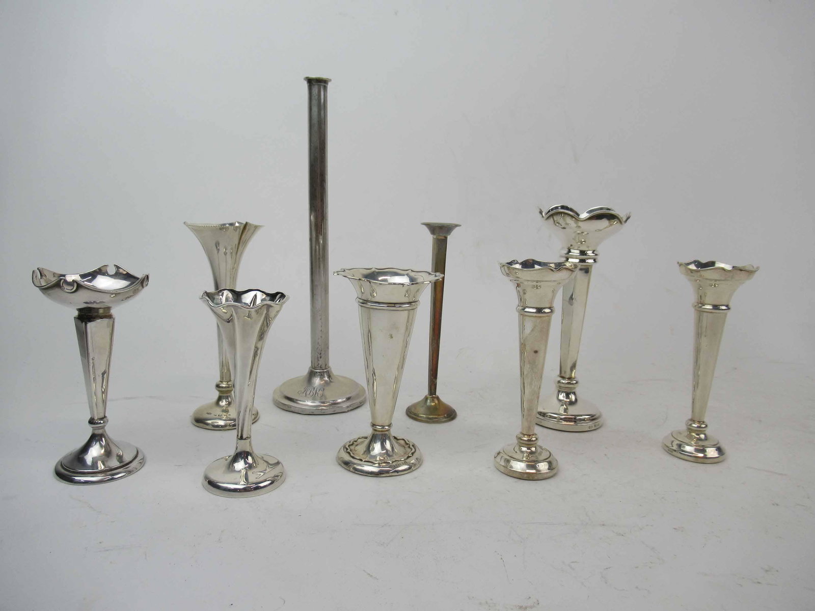Group of Assorted Sterling Silver Weighted Vases: Group of 9 Assorted Sterling Silver Weighted Bud Vases. Including Sanders and Mackenzie, 2 Harrison Brothers & Howson Ltd,Cornelius Desormeaux Saunders & James Francis Hollings, J. Collyer, Cartier, U