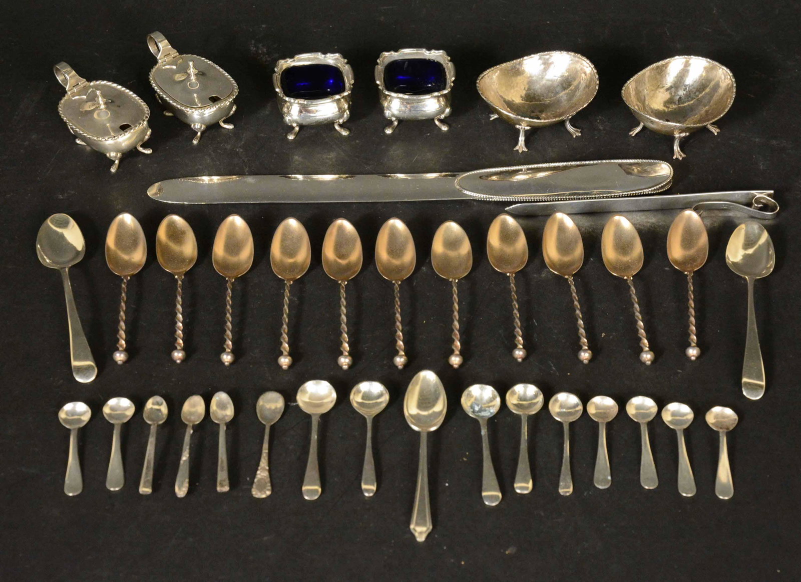 Group of Sterling Silver Items: Comprising two letter openers, a pair of English salt cellars with cobalt blue glass liners,two pair of 800 silver salt cellars, 15 salt spoons, 3 coffee spoons, set of 11 vermeil coffee spoons with t
