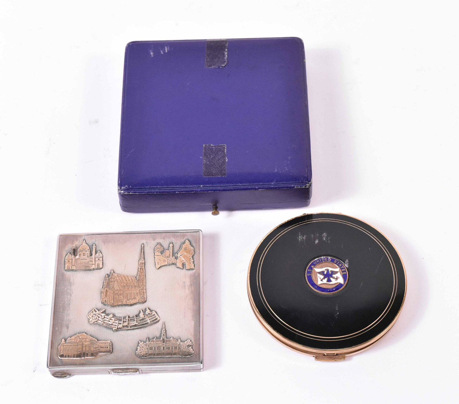 955 Silver Souvenir Compact in a A. Forester Box: Together with a S.S United States blue metal compact. 3"sq.
