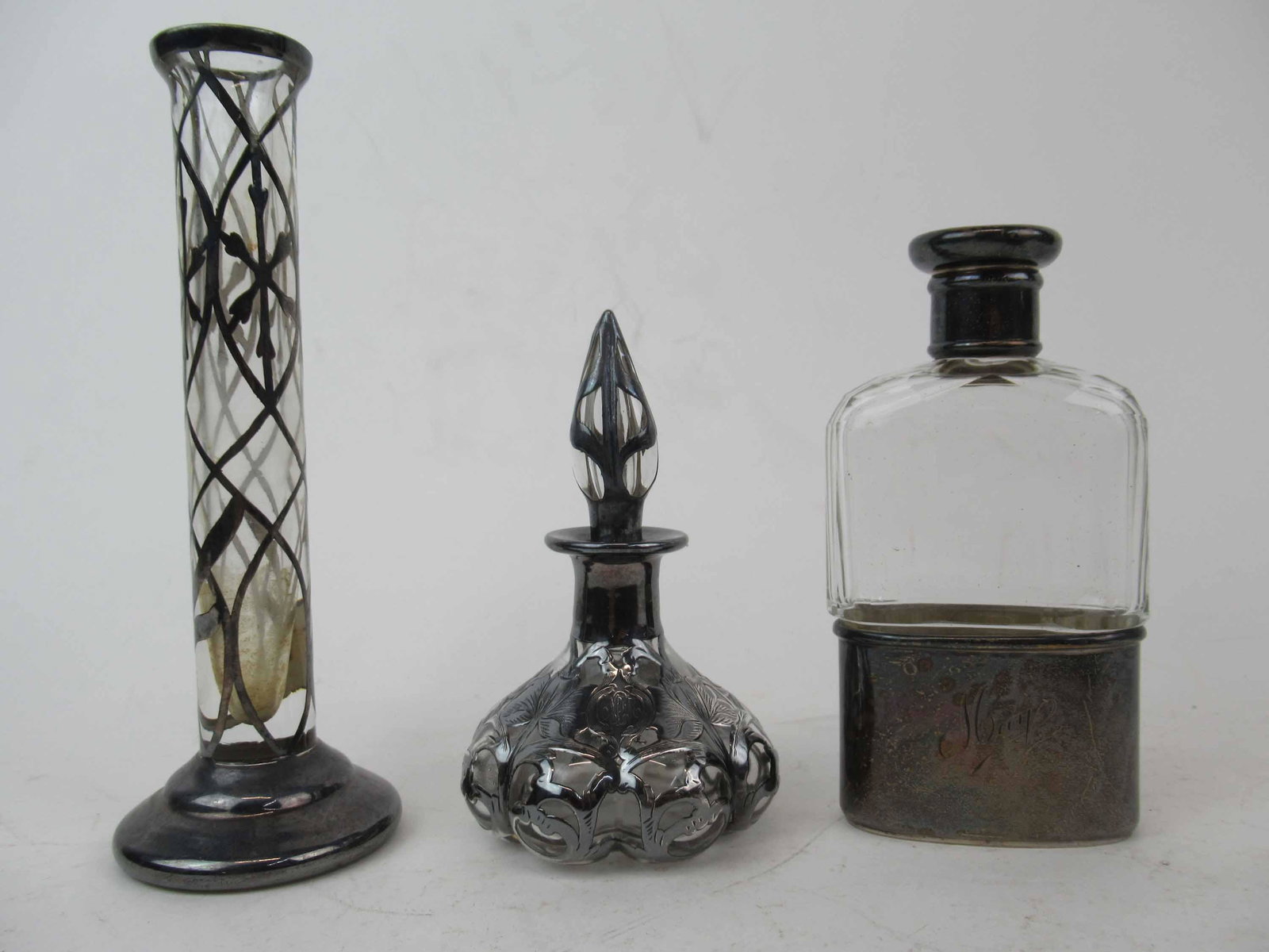 Art Nouveau Sterling Overlay Perfume Bottle: Art Nouveau Sterling Overlay Perfume Bottle marked sterling c182 possibly Alvin. Together with 1918 English silver flask bottle and a silver overlay bud vase. Used condition, broken stopper. Perfume 4