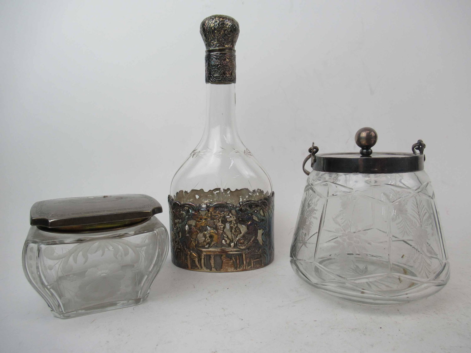 E G Webster & Son Silver Plated Repousse Decanter: E. G. Webster & Son Silver Plated Repousse Decanter. Together with Gorham Sterling lidded dresser jar and a silver plated biscuit jar. Used condition, chip to stopper. Decanter 10 1/4" tall x 4 1/2" w