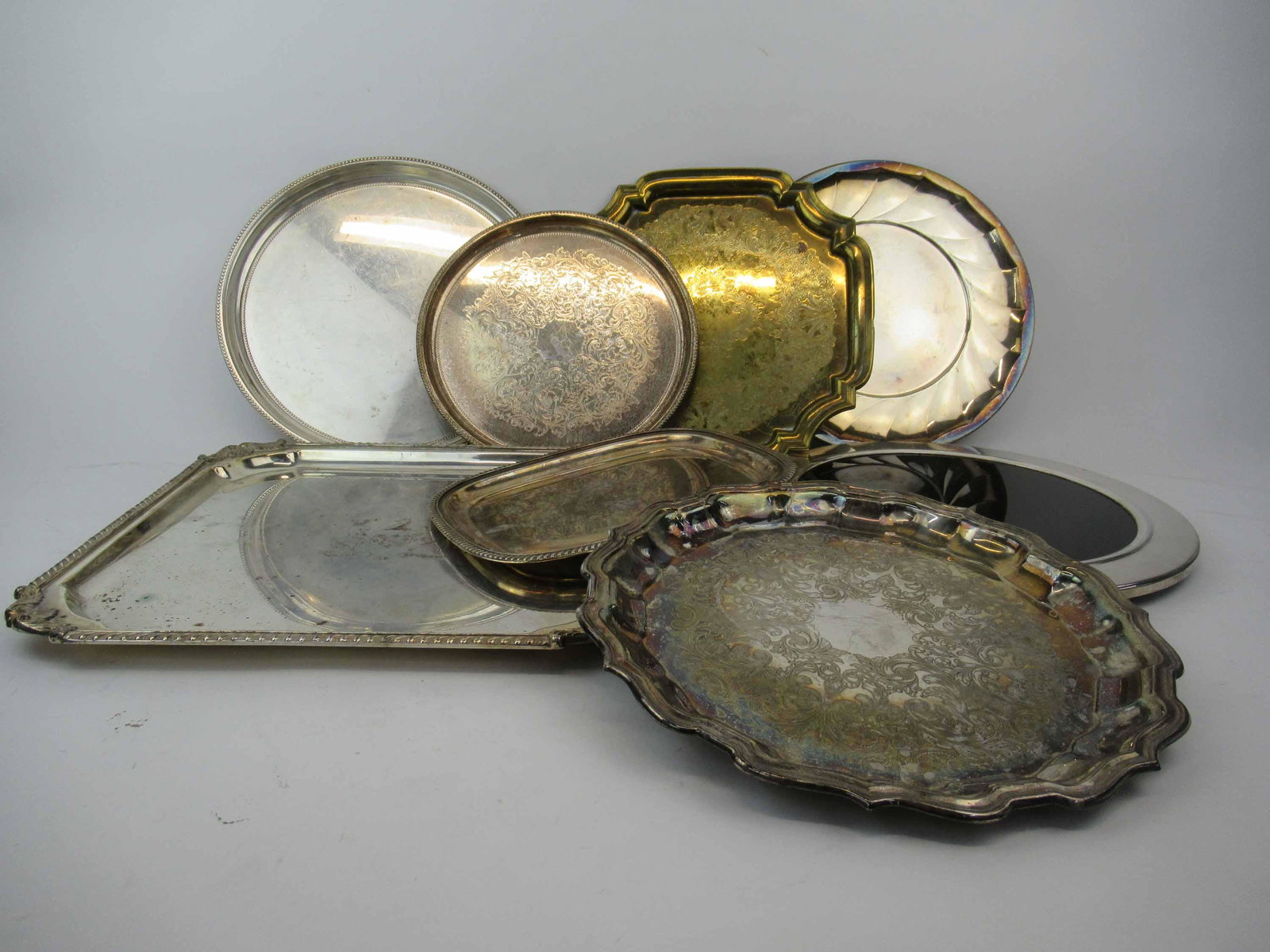 Group of 7 Assorted Silver Plated Serving Trays: Group of 7 Assorted Silver plated Serving Trays. Together with a silver plated circular trivet. Used condition, wear, worn, scratches. largest 14 1/4" x 14 1/4"