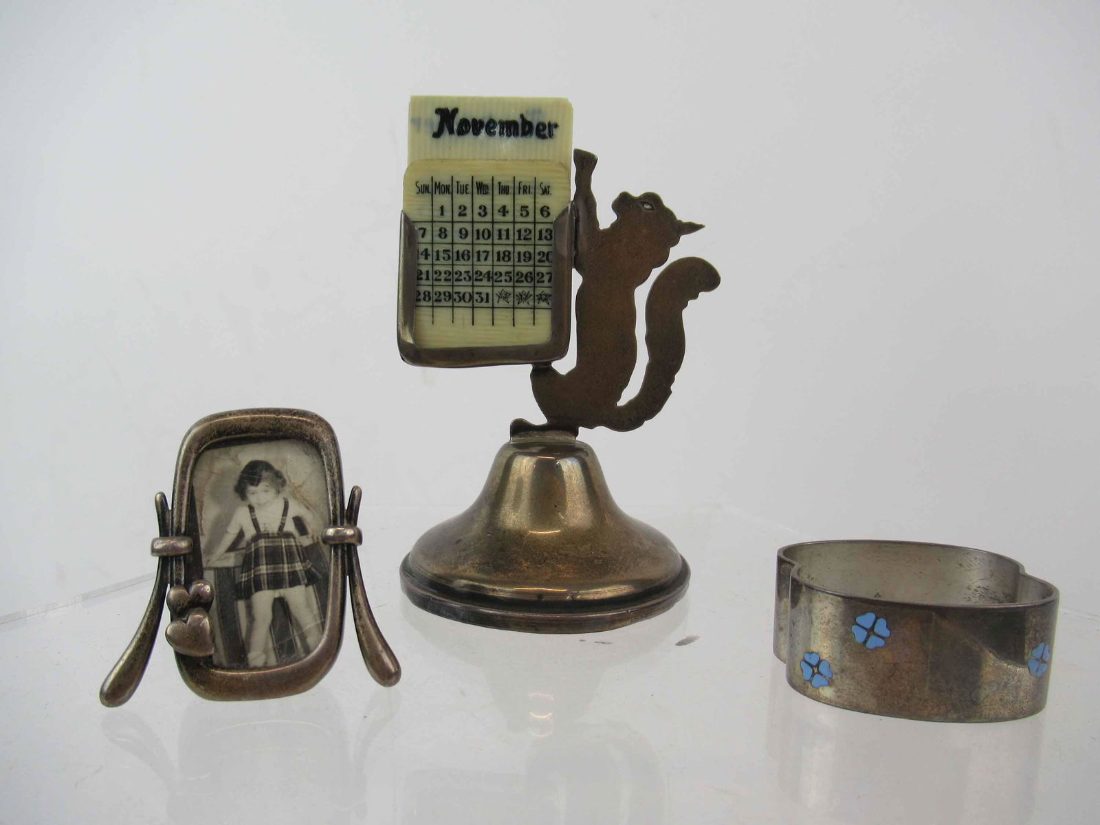 Perpetual Sterling Silver Cat Calendar: Perpetual Sterling Silver Cat Calendar Jacob Rozenzweig Londen. Together a Sterling silver miniature picture frame marked 925 and a danish sterling silver napkin ring with enamel flowers.