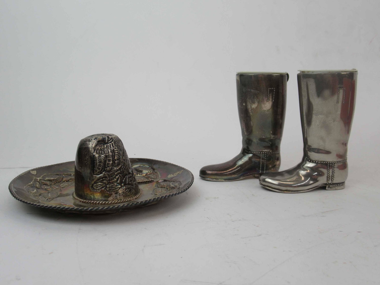 Mexican Sterling Silver Sombrero: Mexican Sterling Silver Sombrero with embossed flowers, 2 t.o.. Together with a pair of Silver plated boot tooth pick holders. Used condition.