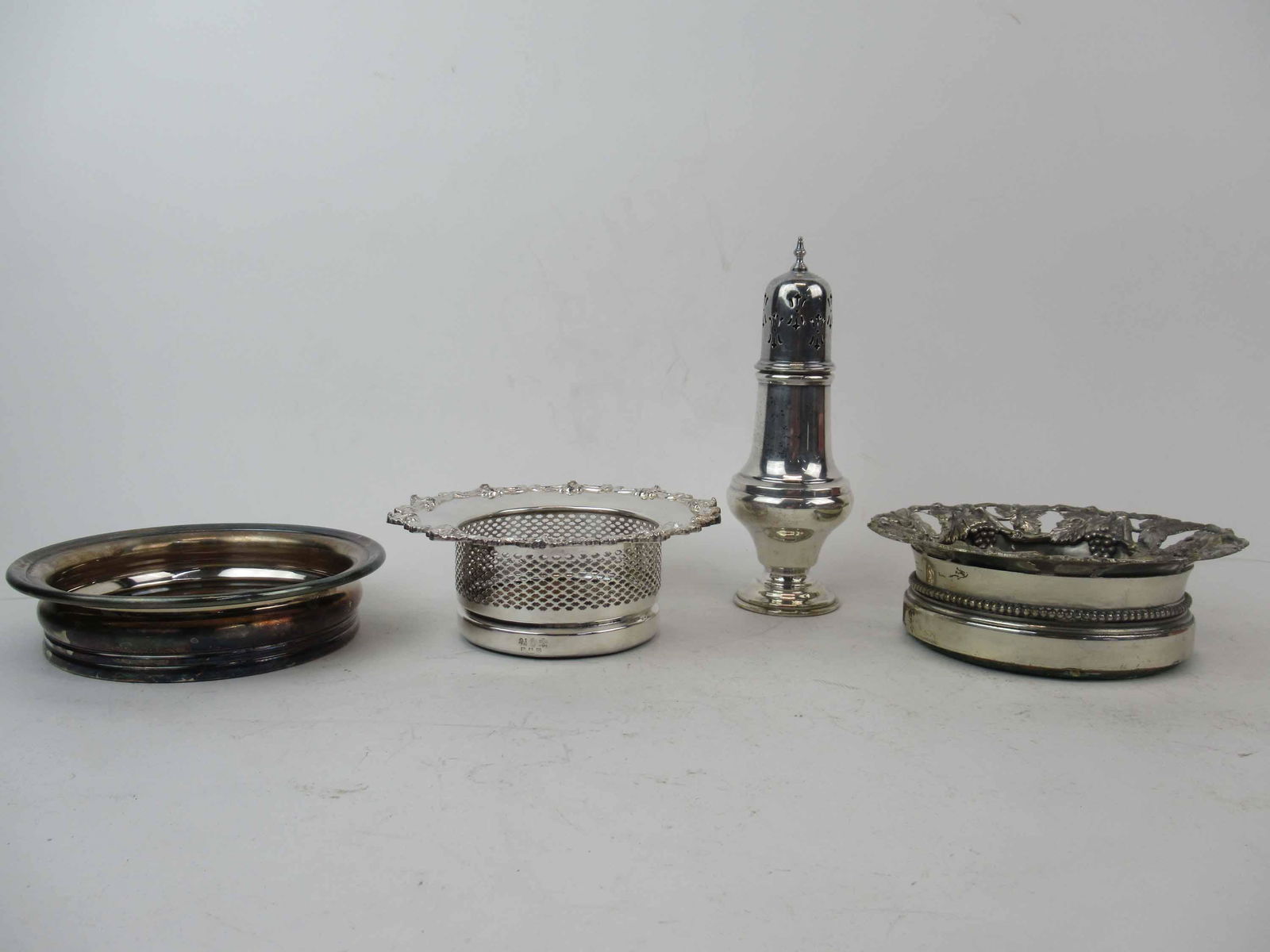 Gorham Silverplated Wine Coaster: Gorham Silverplated Wine Coaster. Together with two wine caddys and a caster. Used condition, wear, worn. Gorham 6 3/4" diameter x 1 1/2" tall